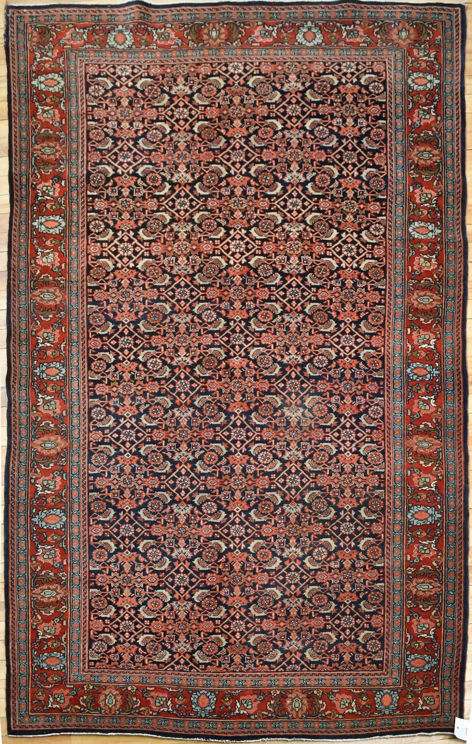 VINTAGE ORIENTAL BOKARA RUG.: A vintage Oriental Bokara area rug, with repeating medallions on rich red ground. 6’9” x 9’4”.