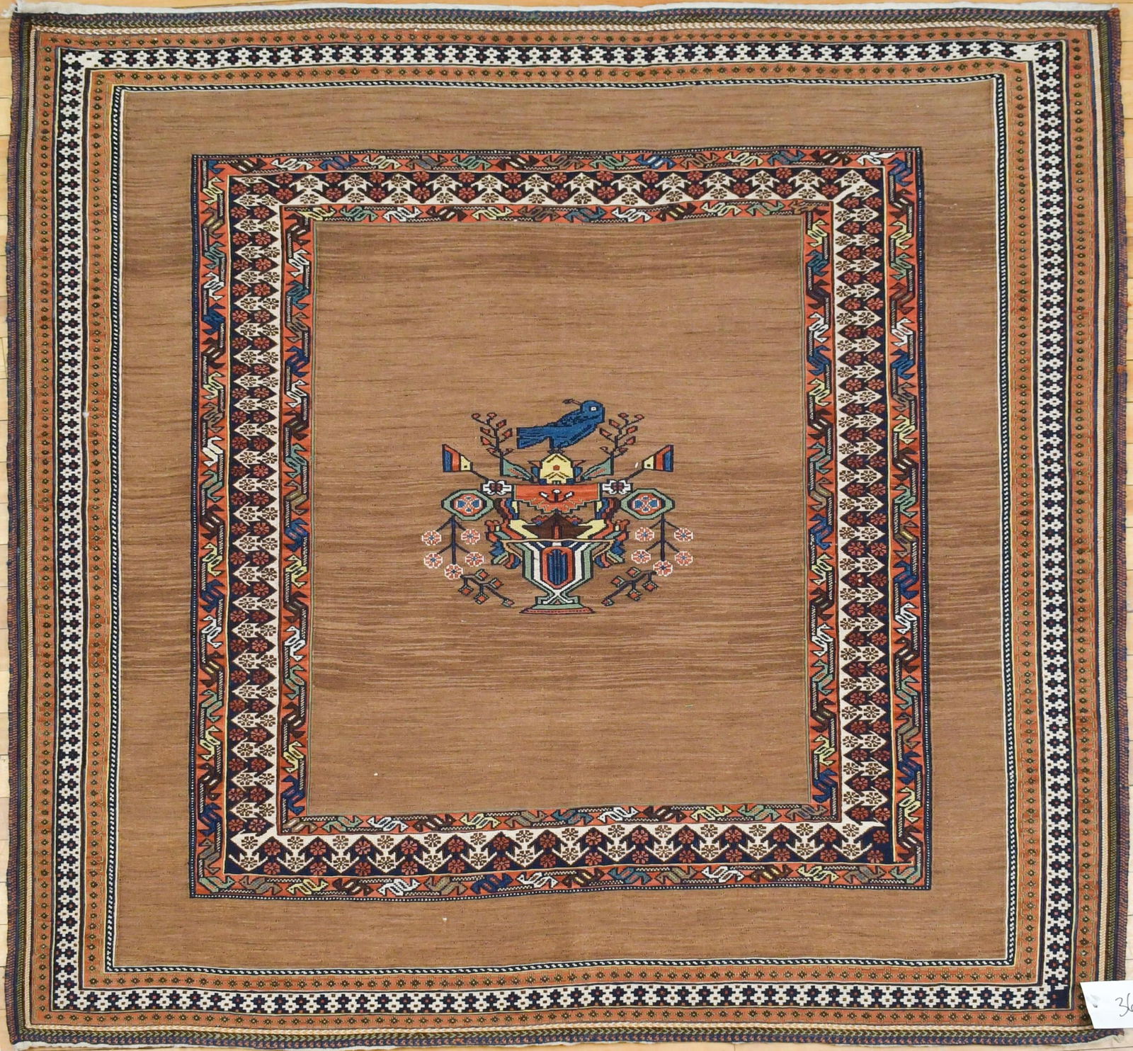 VINTAGE ORIENTAL SOFRA AREA RUG.: A vintage unusual Oriental Sofra rug, central medallion with bird and vase, on espresso brown ground, with complex border. 4’8” x 4’9”.
