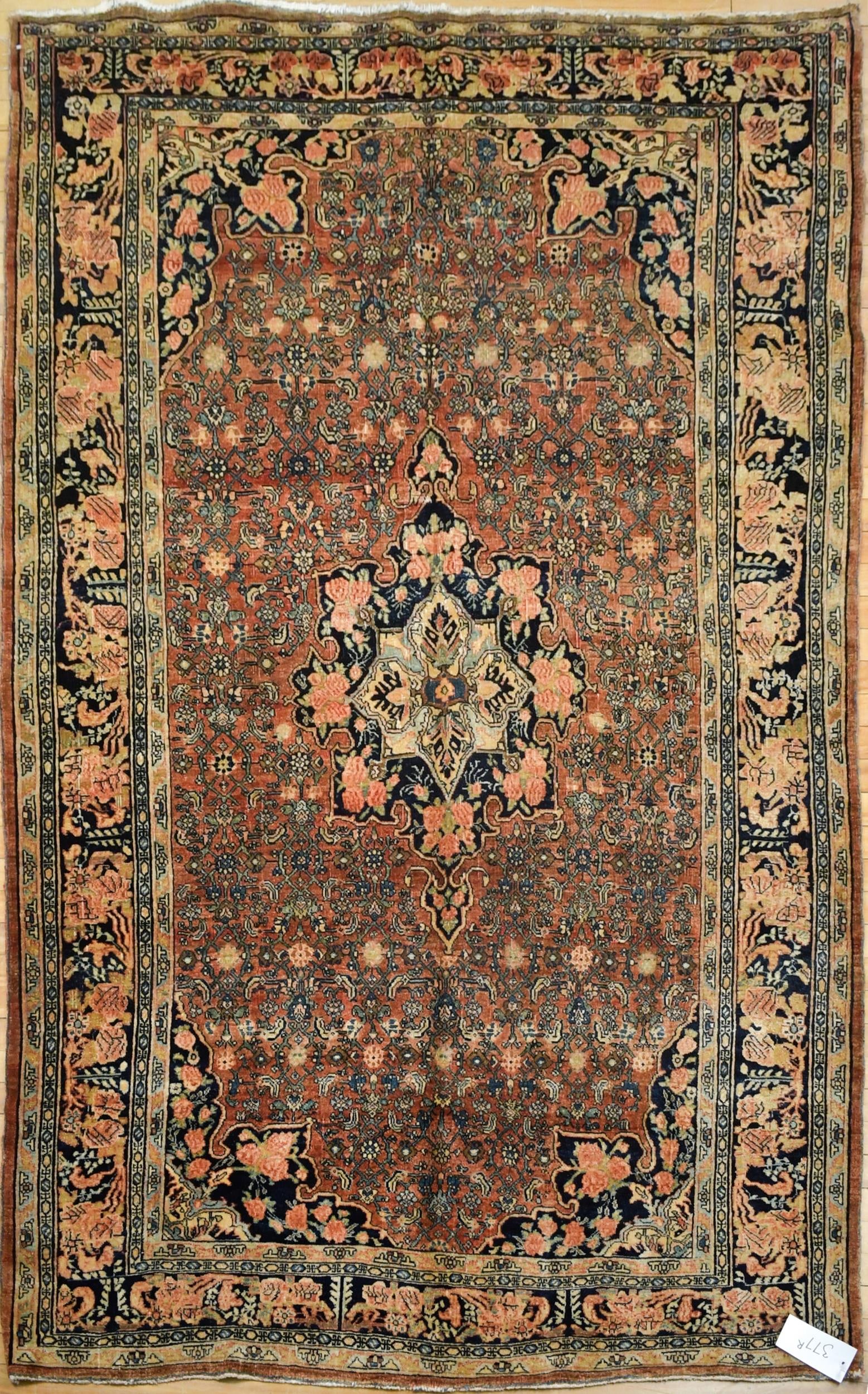 VINTAGE ORIENTAL AREA RUG.: A vintage Oriental scatter rug, with central dark blue and tan medallion, on brick red field, with blue border. 5’4” x 8’2”.