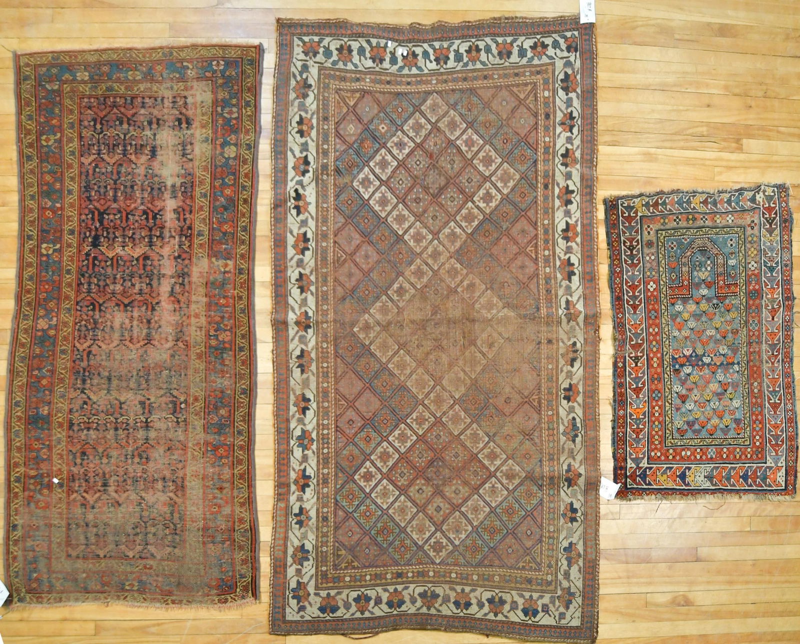 THREE ANTIQUE ORIENTAL RUGS, AS IS.: An estate collection of three heavily worn antique Oriental rugs, including prayer rug 2’9” x 4’. Scatter rug 3’5” x 6’10”. Largest 4’6” x