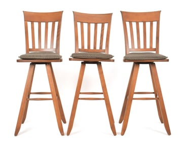 THREE 20TH C. CHERRY BAR STOOLS.