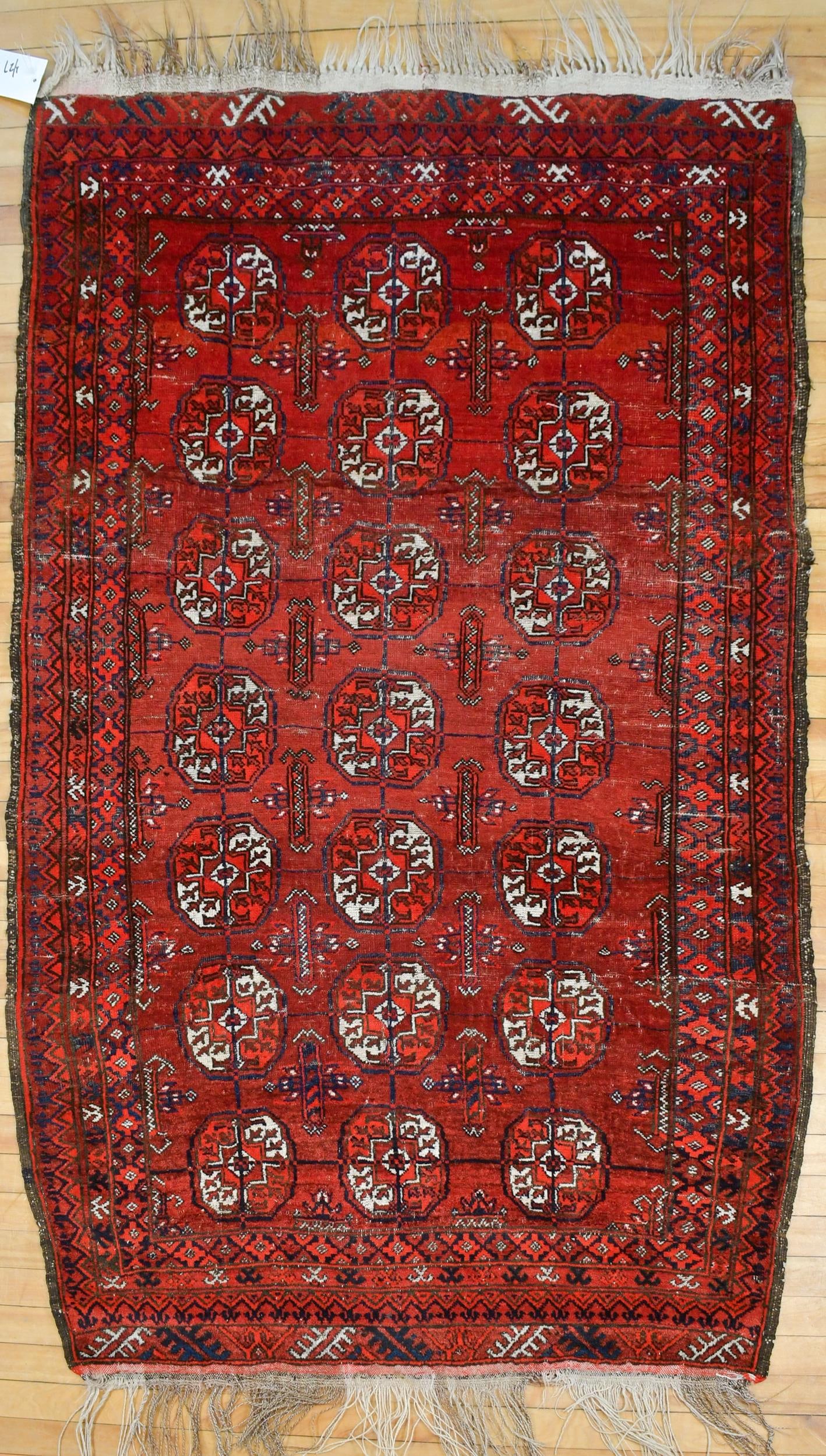 VINTAGE ORIENTAL BOKARA AREA RUG.: A vintage hand woven Oriental Bokara area rug, vibrant red ground, ivory and blue. 4’ x 6’.