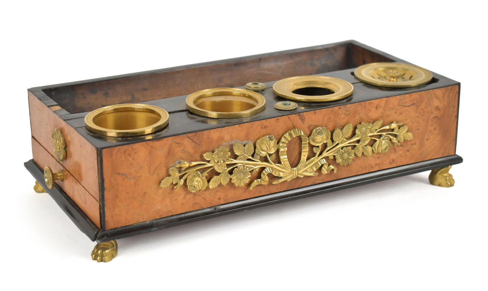 FRENCH EMPIRE BURL VENEER INK STAND.: An early 19th C. French Empire burl wood ink stand, with fine ormolu mounts and ink wells, small drawer on side, with paw feet. 3”H x 10.5”L x 5.5”D. Provenance: Ilse