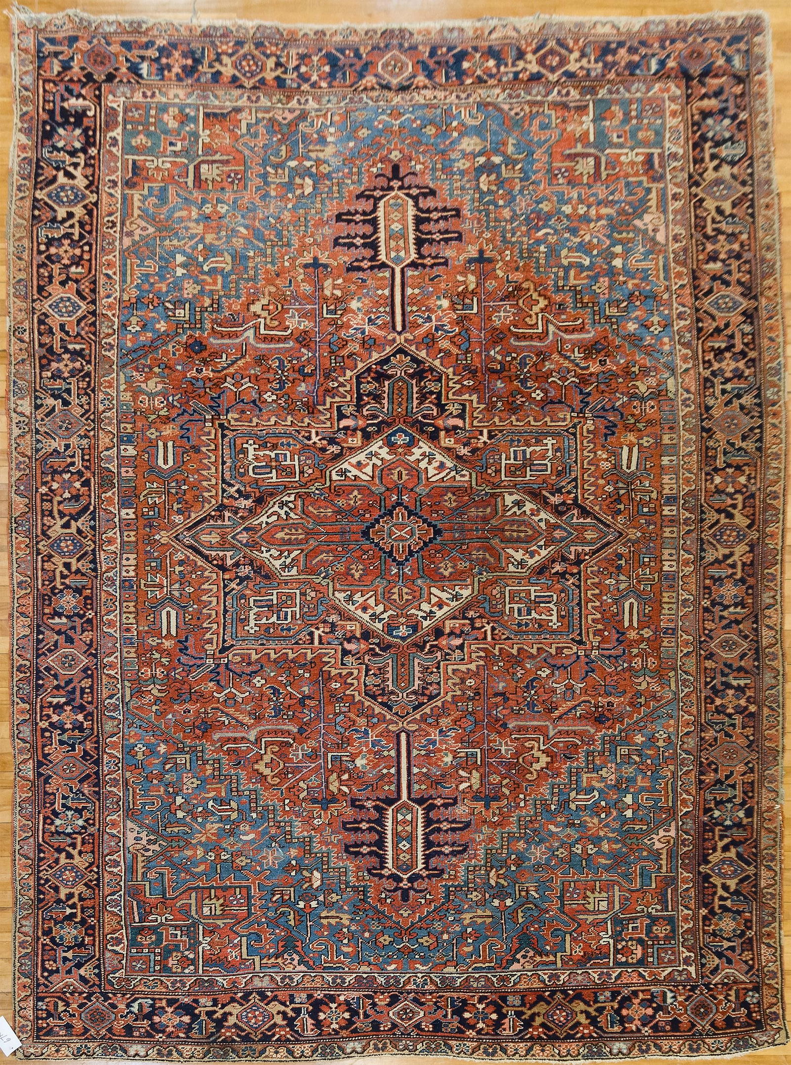 ANTIQUE ROOM SIZE ORIENTAL HERIZ RUG.: An antique hand woven Oriental Heriz rug, with vibrant and complex design, in ivory, green, dark and light blue. 8’8” x 11’8”.