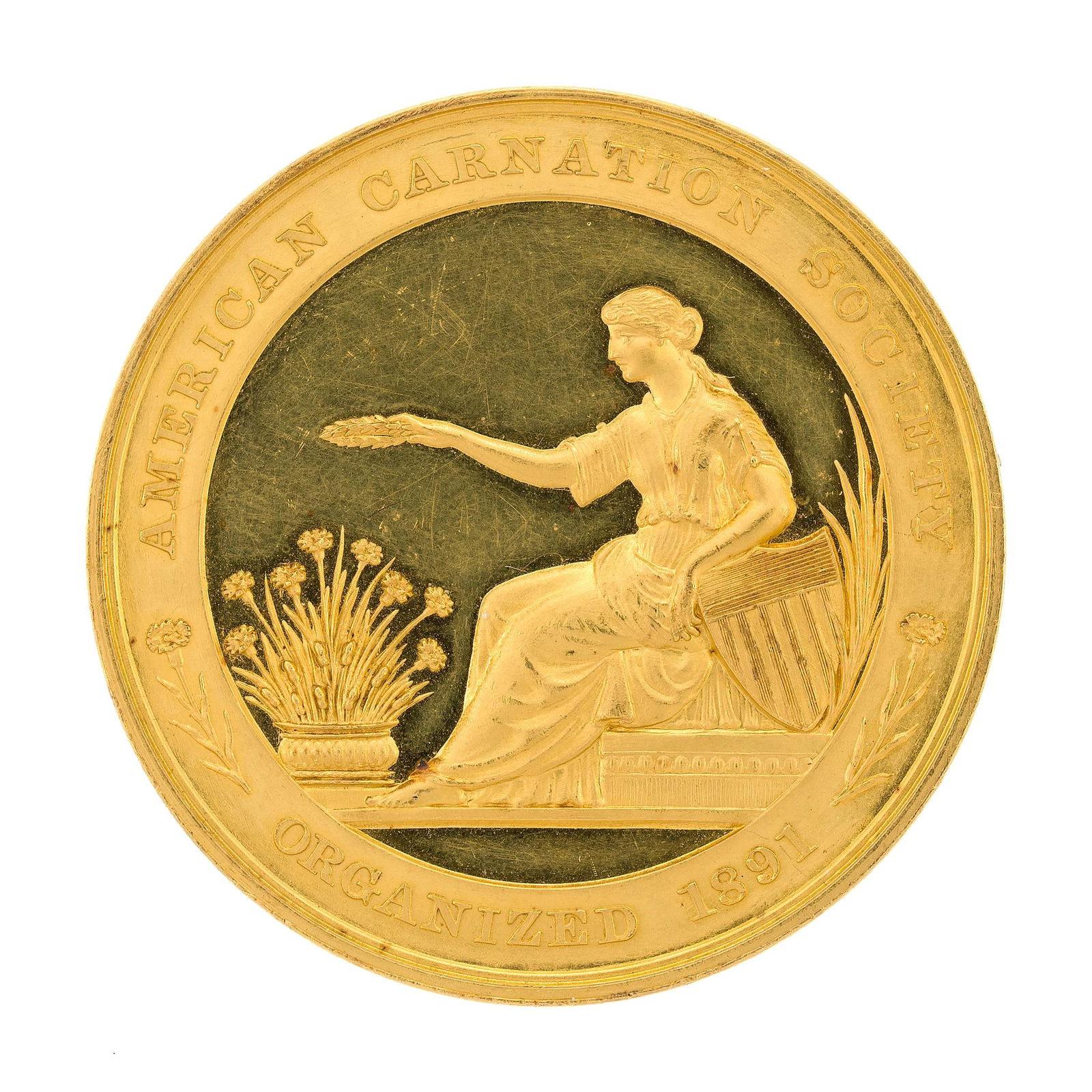 22K GOLD AMERICAN CARNATION SOCIETY MEDAL.: A ca. 1910 22k yellow gold (tested) medal awarded by the The American Carnation Society to F. Dorner & Sons Co. of Lafayette, Indiana, the developers of the carnation, engraved ”Carnation