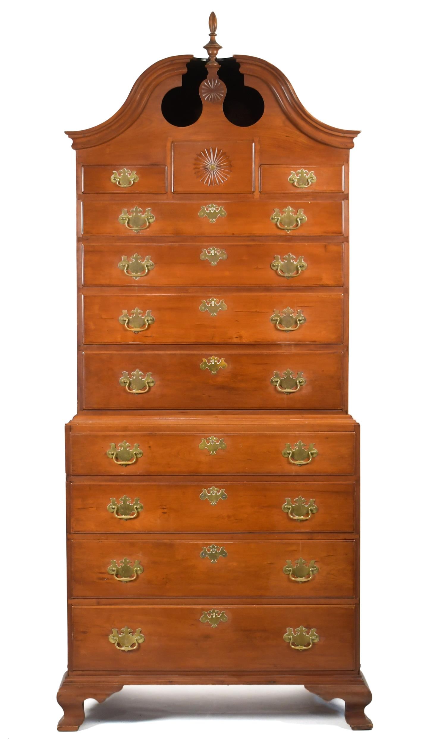18TH C. CT CHIPPENDALE CHERRY CHEST ON CHEST.: A ca. 1780 Connecticut two-part bonnet top cherry chest on chest. The top section with an applied molded full bonnet top with a center pinwheel carved pediment, over three short drawers and four long