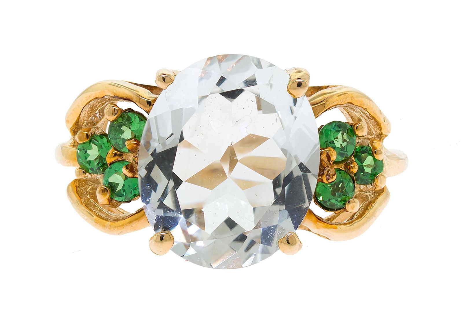 14K GOLD AQUAMARINE & TSAVORITE GARNET RING.: A 14k yellow gold gold (stamped) ring set with an approx. 4.20 ct., faceted oval, light blue aquamarine and approx. .30 ct. tw., faceted round, medium dark green, tsavorite garnet. Ring size 6 1/4, 12