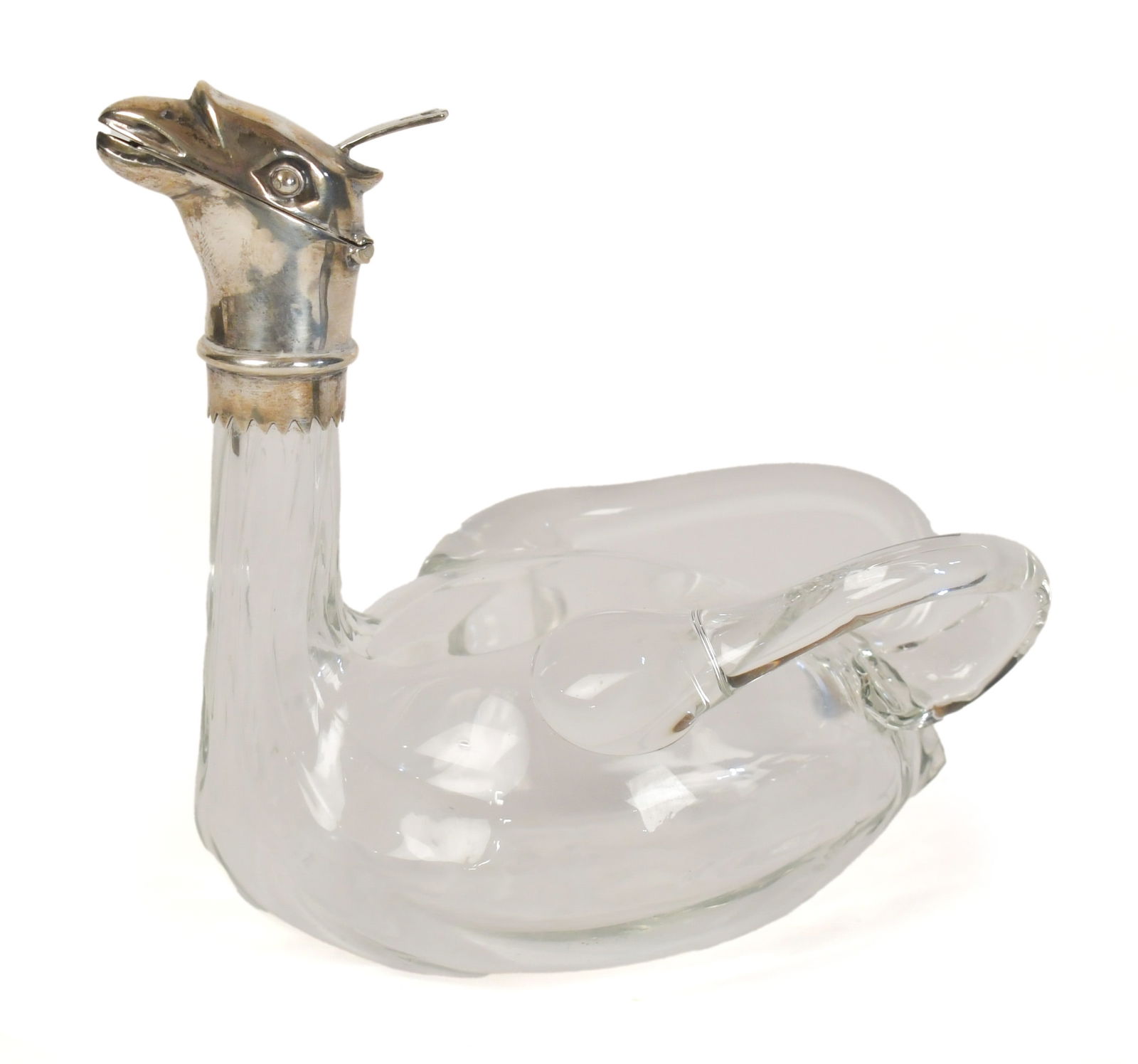 ANTIQUE GLASS AND SILVER MOUNTED CLARET JUG.: A 1901 William Richard Clarke of London glass and silver-mounted griffin form claret jug with hinged silver spout, three-toed thumb rest, fluted neck, clear glass wing handles, and hallmarks on sterli