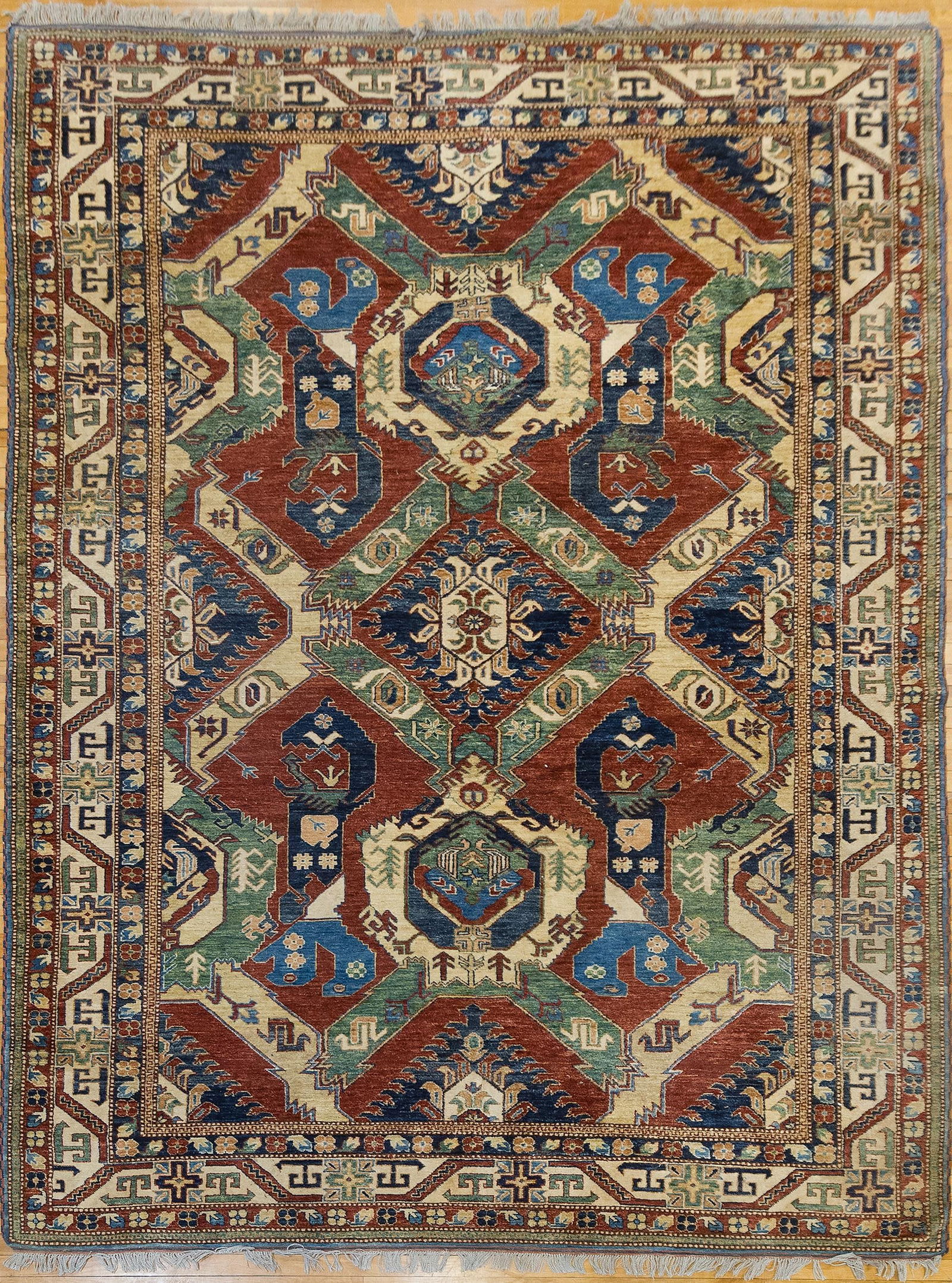 VINTAGE ROOM SIZE ORIENTAL RUG.: A vintage Oriental room size rug, in green, dark blue, and red geometric motifs. 8’2” x 11’.
