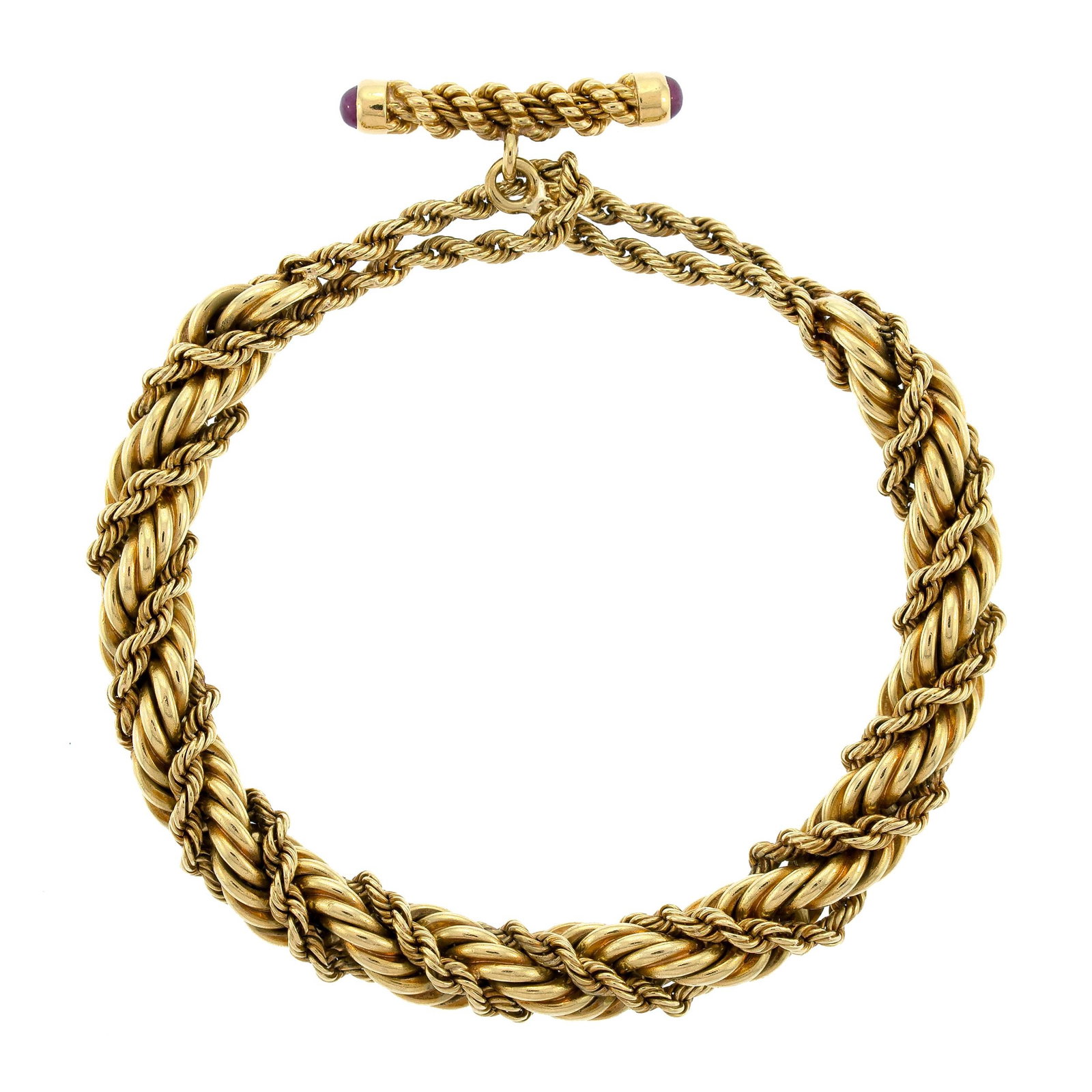 VINTAGE TIFFANY SCHLUMBERGER 18K GOLD BRACELET.: A vintage, signed, Tiffany & Co., Schlumberger, 18k yellow gold (stamped) double twisted rope bracelet with approx. .40 ct. tw., ruby cabochon, toggle clasp, 8mm thick at center, 8 5/8 inches long, 65