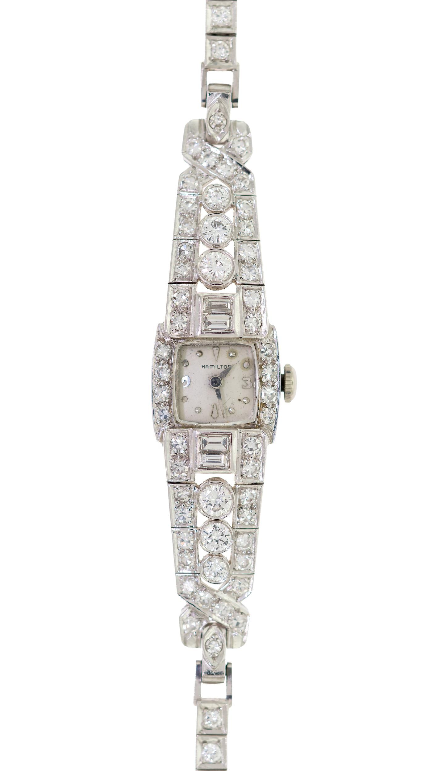 ART DECO HAMILTON PLATINUM DIAMOND WRIST WATCH.: An Art Deco, Hamilton platinum (stamped) wrist watch, mechanical movement, set with approx. 3.75 ct. tw., round brilliant, single and baguette cut, natural diamonds of G-H color and VS clarity, 14mm w