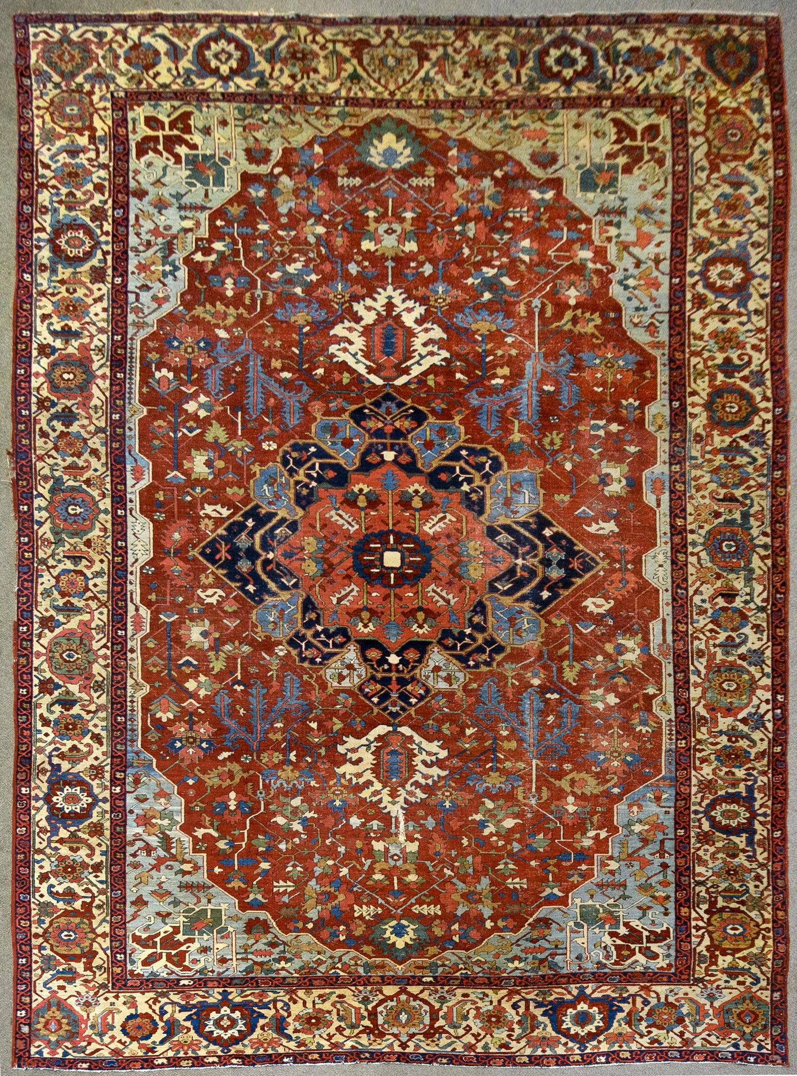 FINE ANTIQUE SERAPI HERIZ ORIENTAL RUG.: A good antique hand woven Oriental Serapi/Herix room size rug with desirable brick red ground, highlighted with aqua blue, green, cobalt blue and tan. 11’ x 17’eight.