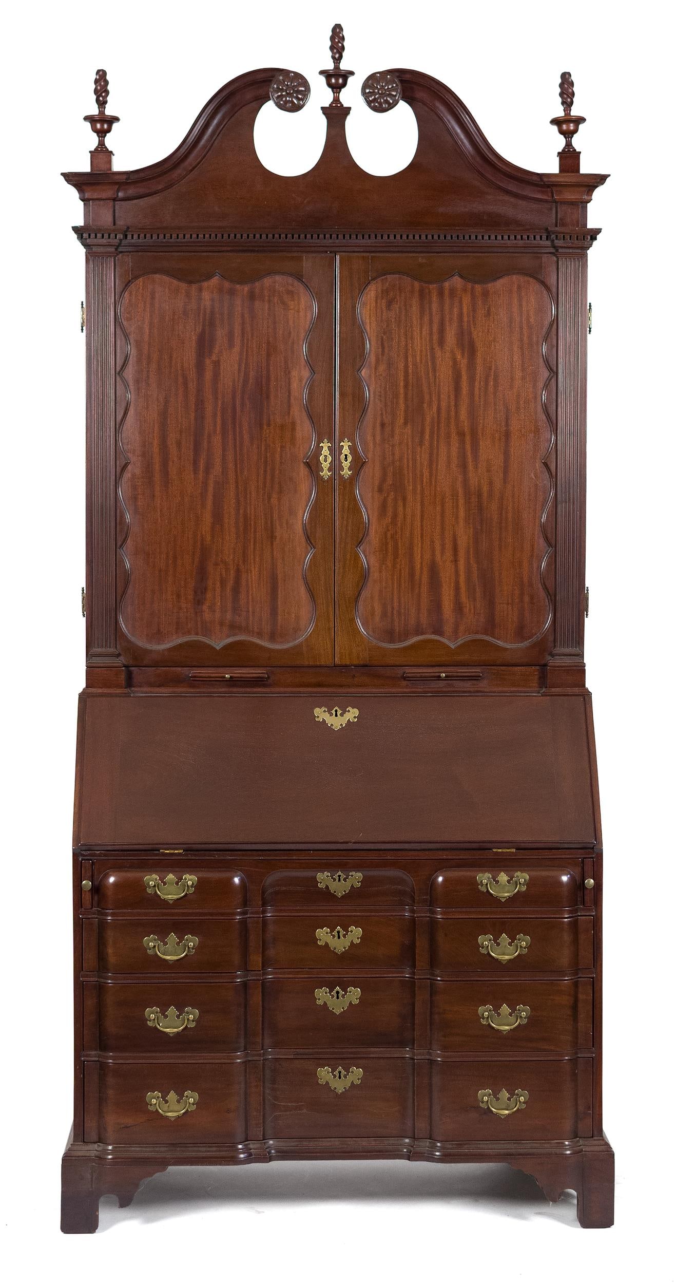18TH C. NE CHIPPENDALE BLOCK FRONT SECRETARY.: A ca. 1770 New England and possibly Rhode Island three-part mahogany Chippendale bookcase secretary. A removable cyma scrolled pediment having carved rosettes, urn-and-flame finials, and dentil moldin