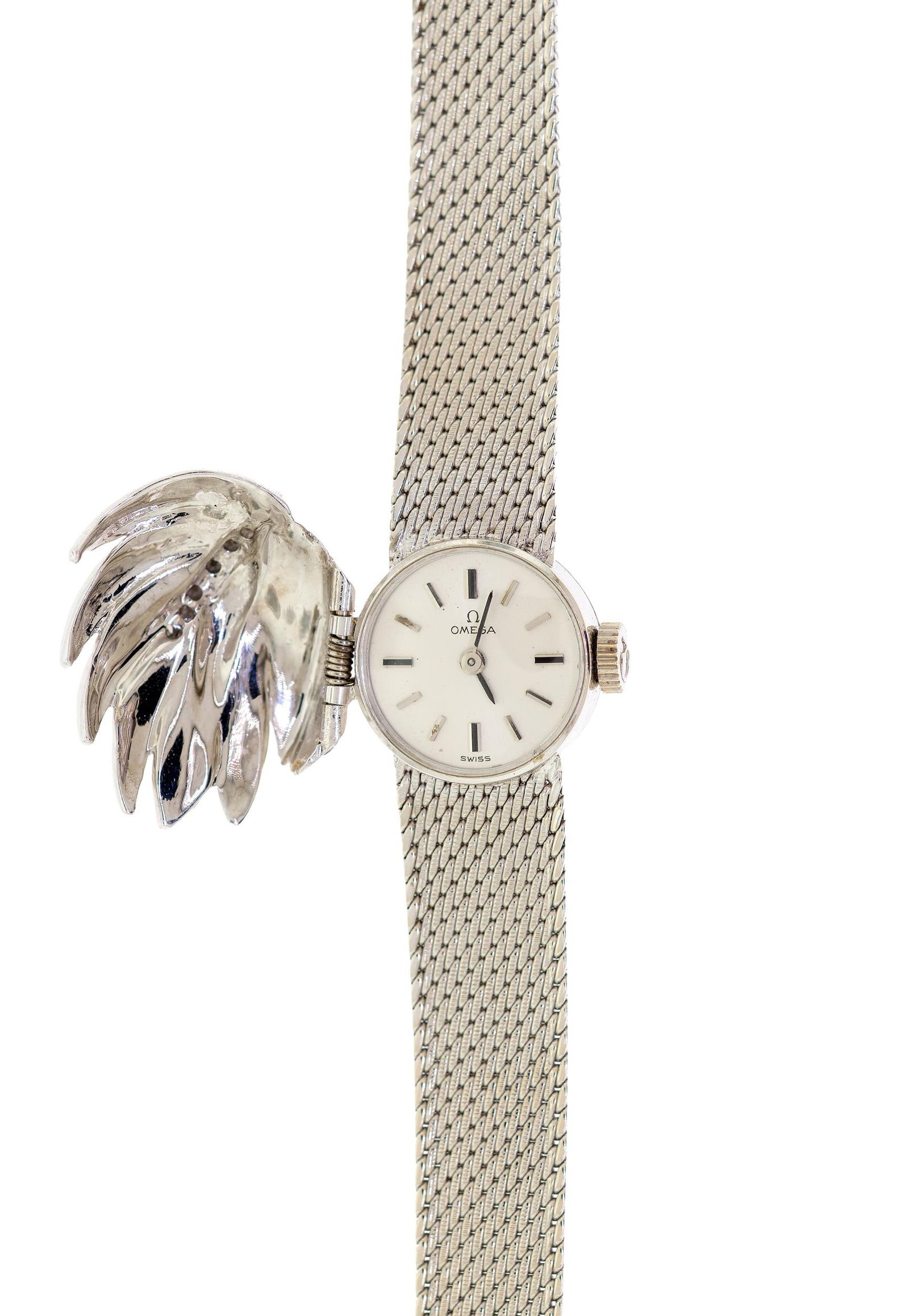 VINTAGE 14K GOLD LADY'S OMEGA DIAMOND WRIST WATCH.: A lady's vintage, 14k white gold (stamped), Omega, dress wrist watch, mechanical movement with a spring-hinged cover set with approx. .06 ct. tw., single cut diamonds of G color and VS clarity, 16.5mm