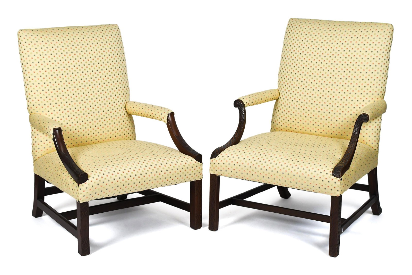 TWO 18TH C. CHINESE CHIPPENDALE LOLLING CHAIRS.: Two ca. 1780 Chippendale mahogany lolling chairs with fine Chinese Chippendale carvings, on straight carved legs and stretcher base, both in lovely pale yellow upholstery. 42” H x 28”W x