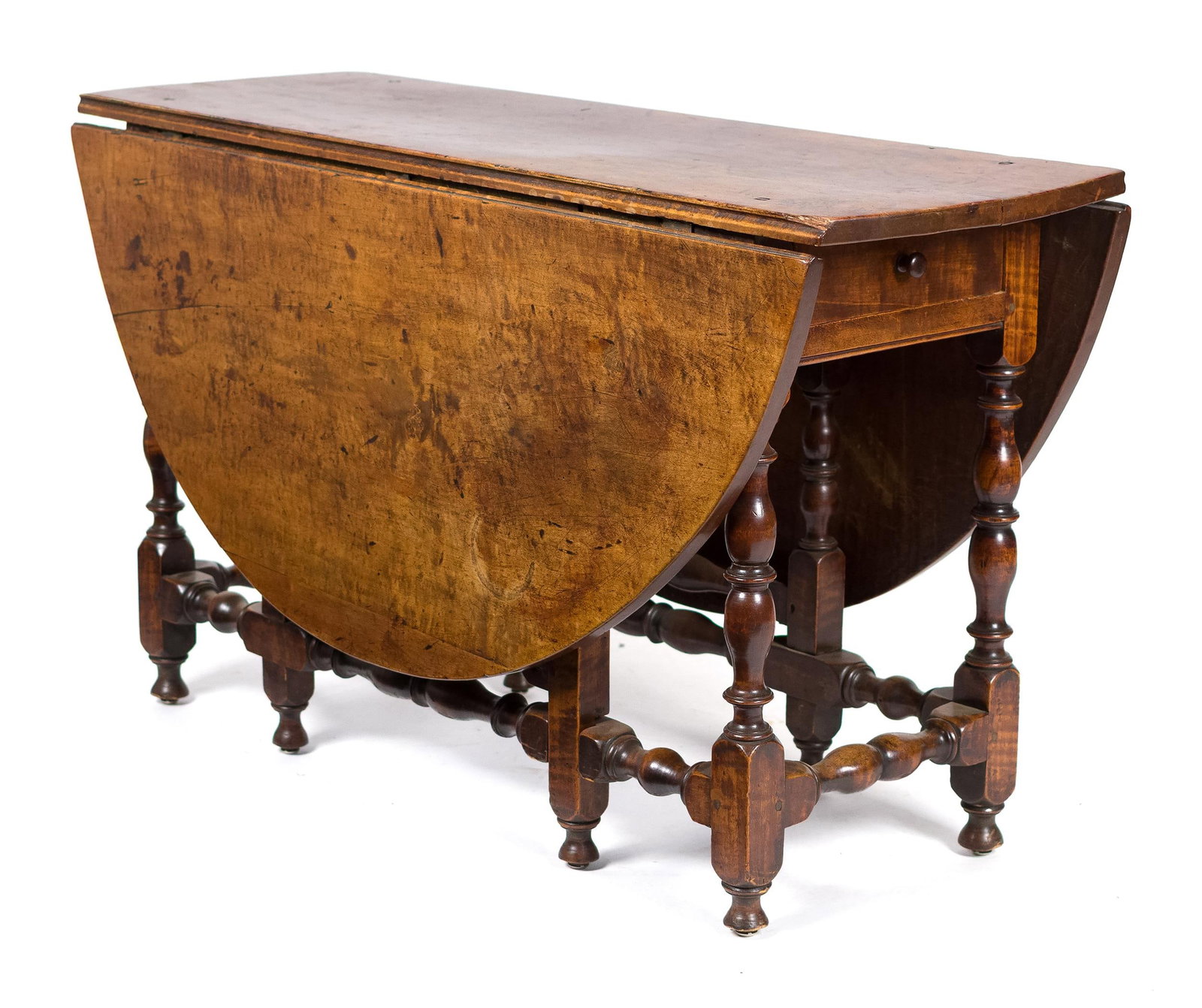 18TH C. NE WILLIAM & MARY MAPLE GATE LEG TABLE.: A ca. 1720 New England figured maple drop leaf gate-leg dining table with drawer and refined vase and ring turnings. 28”H x 47”L x 17”W (leaves down) x 59”W (leaves up).