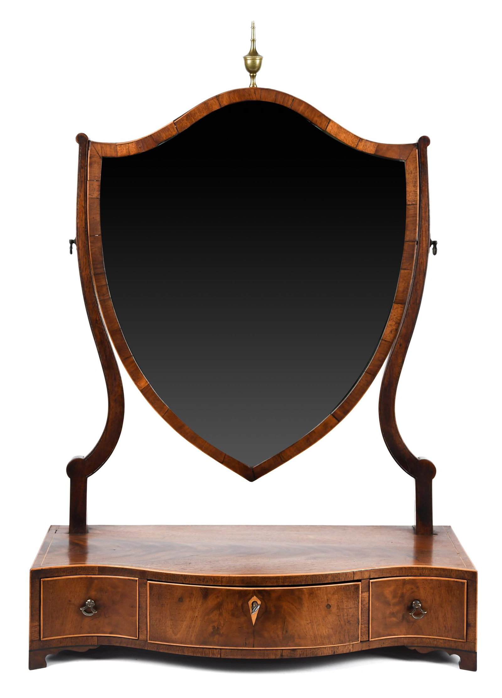 ANTIQUE ENGLISH SERPENTINE DRESSER MIRROR.: A 19th C. English mahogany dresser mirror, a shield shaped mirror with brass finial, base with a serpentine front with three drawers, on small feet. 37”H x 18.75”W x 8.75”D.