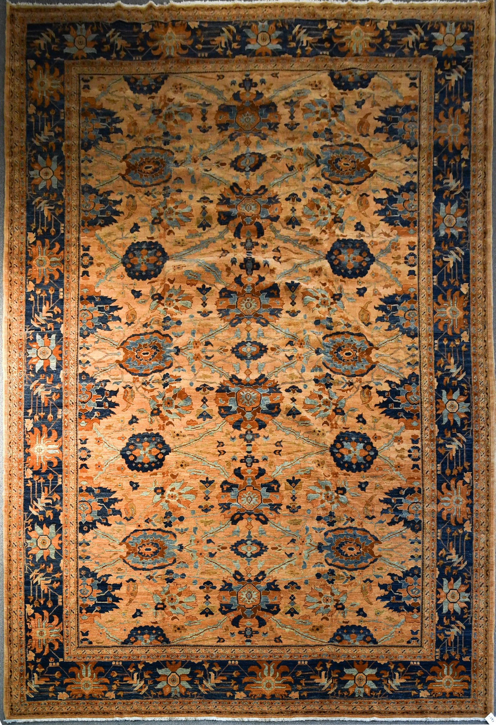 LARGE VINTAGE ORIENTAL ROOM SIZE RUG: A good Oriental hand woven vintage room size rug, with unique copper orange ground, with repeating small medallions in blue and light blue. 12'2” x 17'6”.