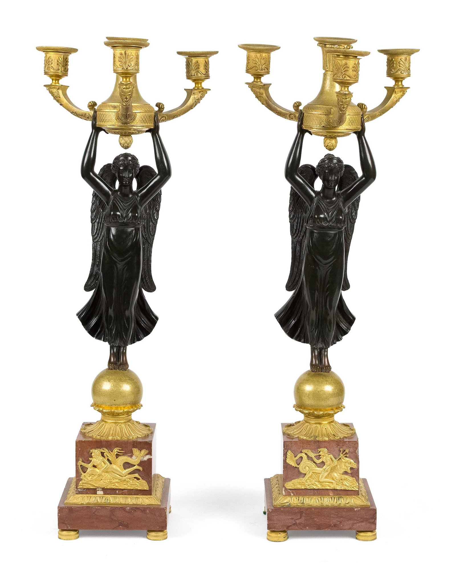 PR. 19TH C. FRENCH EMPIRE BRONZE CANDELABRAS.: A pair of 19th C. French Empire bronze and ormolu candelabra, each with four candle cups, bronze angel supports, on red marble base with ormolu decoration of sea nymphs and dolphins. 23.25”H x t
