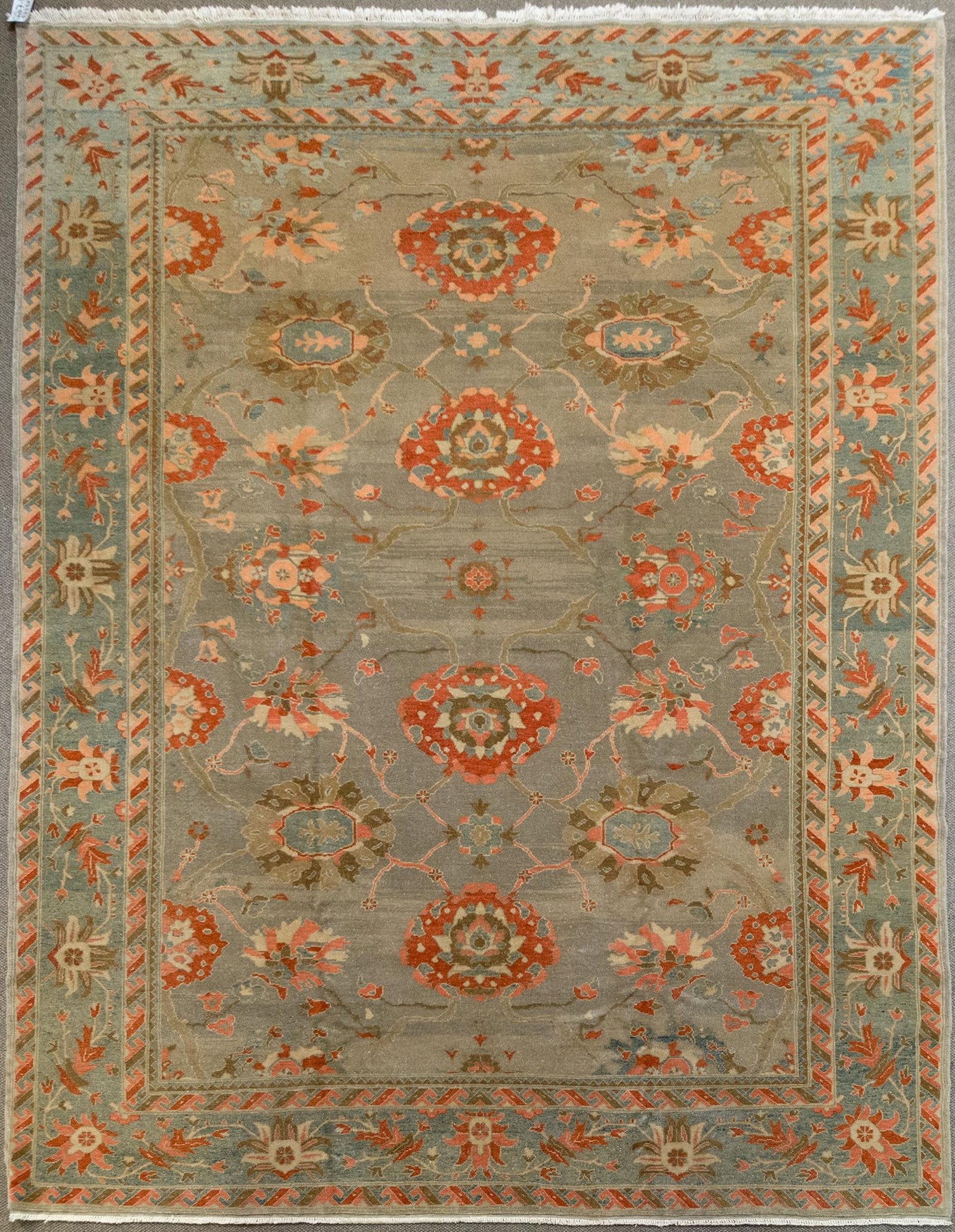 VINTAGE ORIENTAL OUSHAK ROOM SIZE RUG.: A vintage hand woven Oriental Turkish Oushak design room size rug with soft green ground, highlighted with salmon and ivory. 9' 2” x 11'10”.