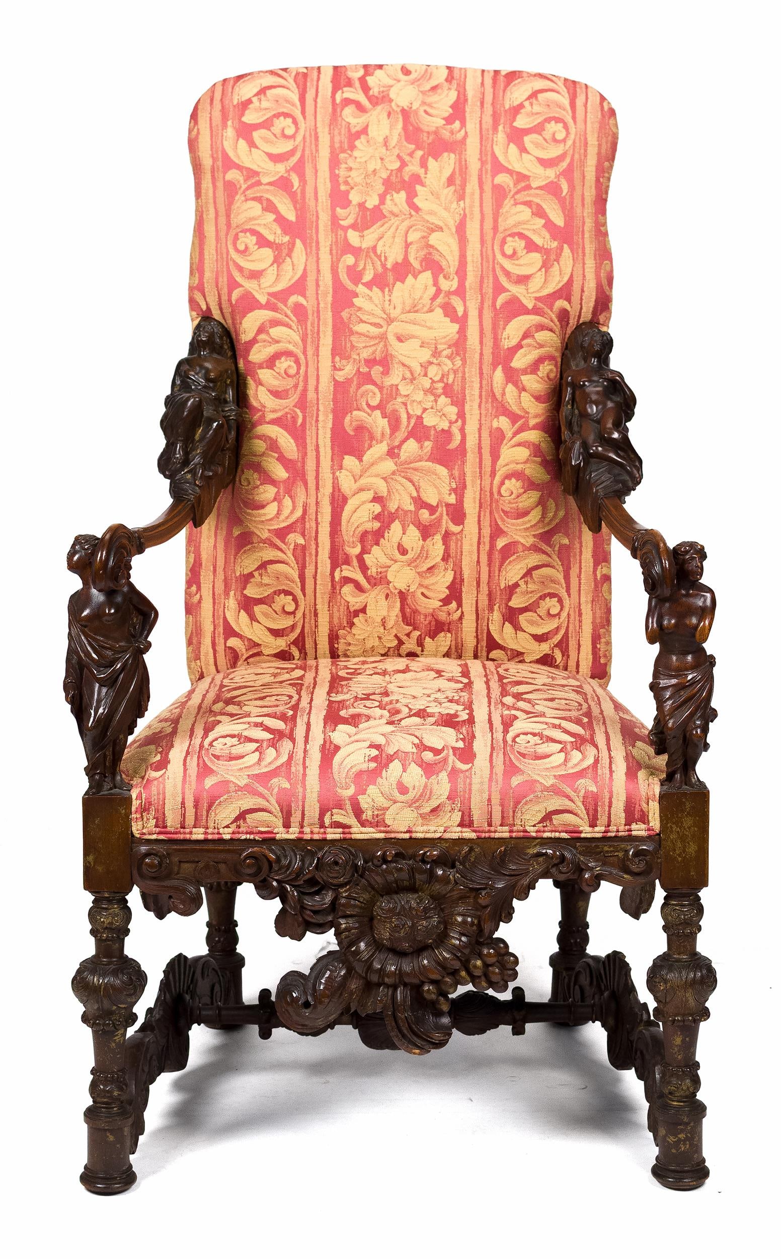 SUPERB ANTIQUE ITALIAN CARVED ARMCHAIR.: An antique Italian armchair with elaborate carved wooden frame, slim arms with bold figural arm supports, sunburst drop pediment, with shell carved stretchers. Traces of gilding throughout. In a red