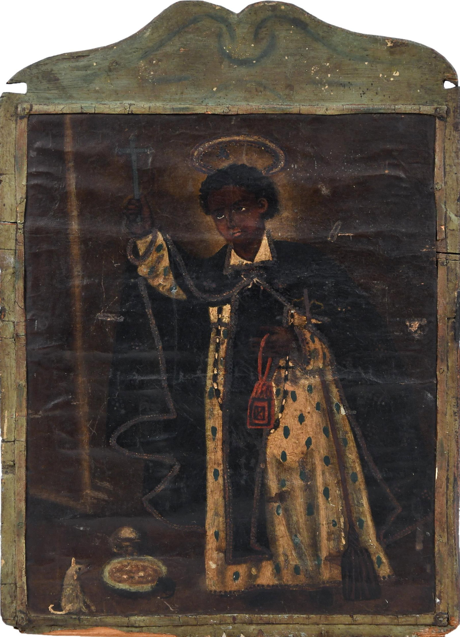 ANTIQUE OIL, SAINT BENEDICT OF PALERMO.: An antique oil on canvas, of a saint, likely Saint Benedict of Palermo, in robes holding a cross and red bag, with animals eating from bowl at feet. Canvas laid on green painted wooden board/frame.