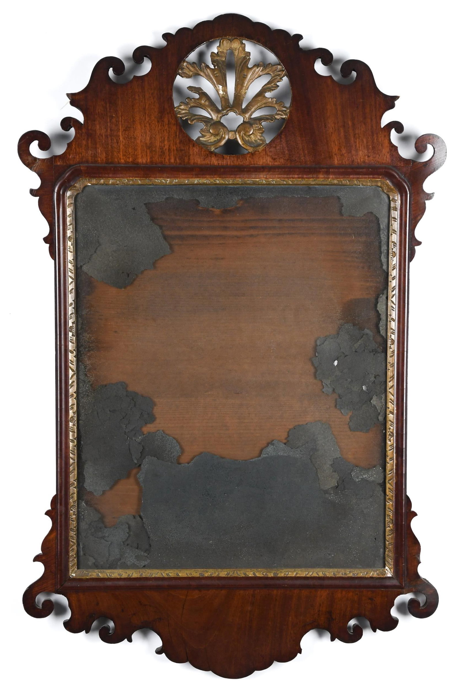 18TH C. CHIPPENDALE WALL MIRROR.: An 18th C. Chippendale mahogany wall mirror with an exceptional scroll cut and pierced parcel gilt crest and period mirror plate. 36”H x 24”W.