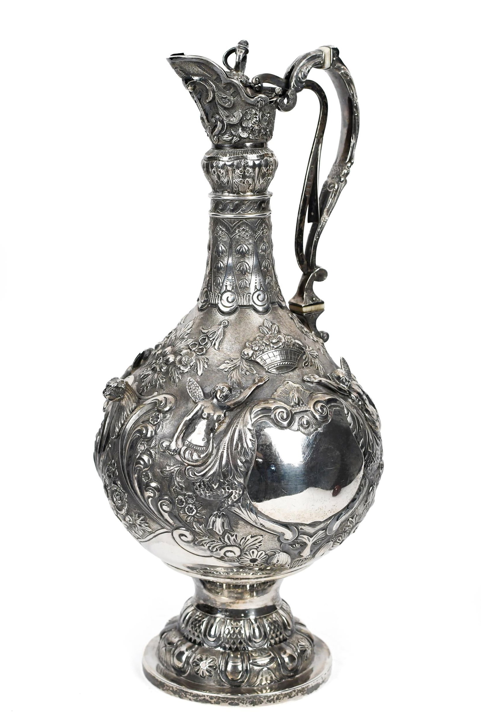 FINNISH SILVER PITCHER, TARKIAINEN MAKER.: An antique Finnish silver pitcher with bold repousse and high relief decoration. Marked on foot 'Tarkiainen 813N' (81.3% silver purity). With a later added lid and handle mechanism, stamped W&S with h