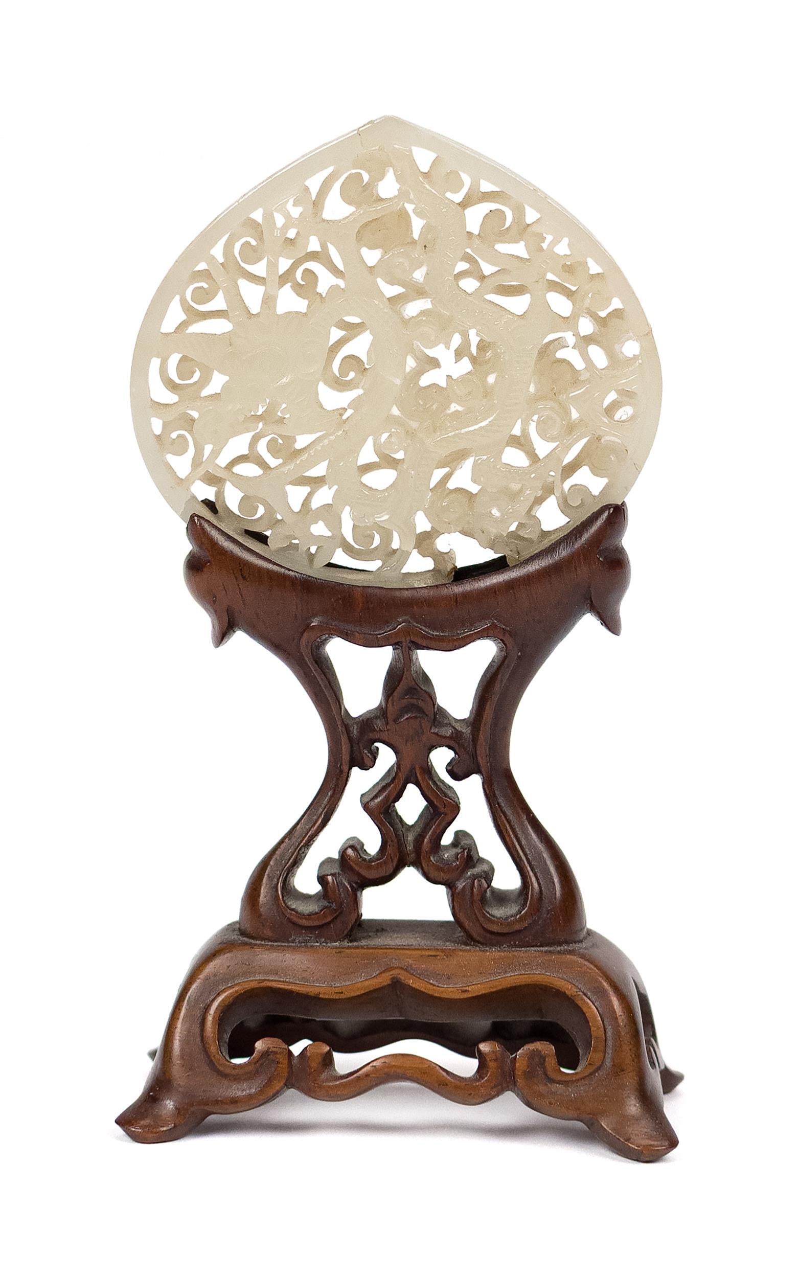 ANTIQUE RETICULATED CARVED CHINESE JADE WITH STAND.: A finely carved antique reticulated Chinese jade dragon medallion with conforming carved stand. Medallion 2.25” x 2.25”, Overall on stand 5.25”H. Provenance: from a private CT collec