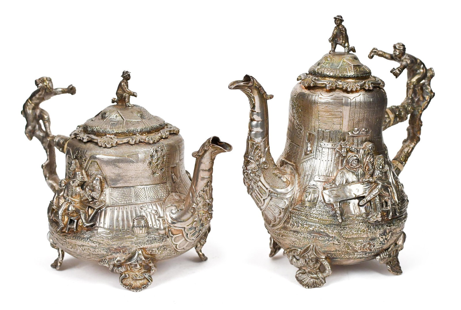 TWO 19TH C. ENGLISH STERLING TENIERS STYLE TEAPOTS.: Two 19th C. English sterling silver Tenier’s style teapots, named such after the high relief depictions of David Tenier the Younger’s artwork, of tavern scenes and inebriated townsfolk. Ma