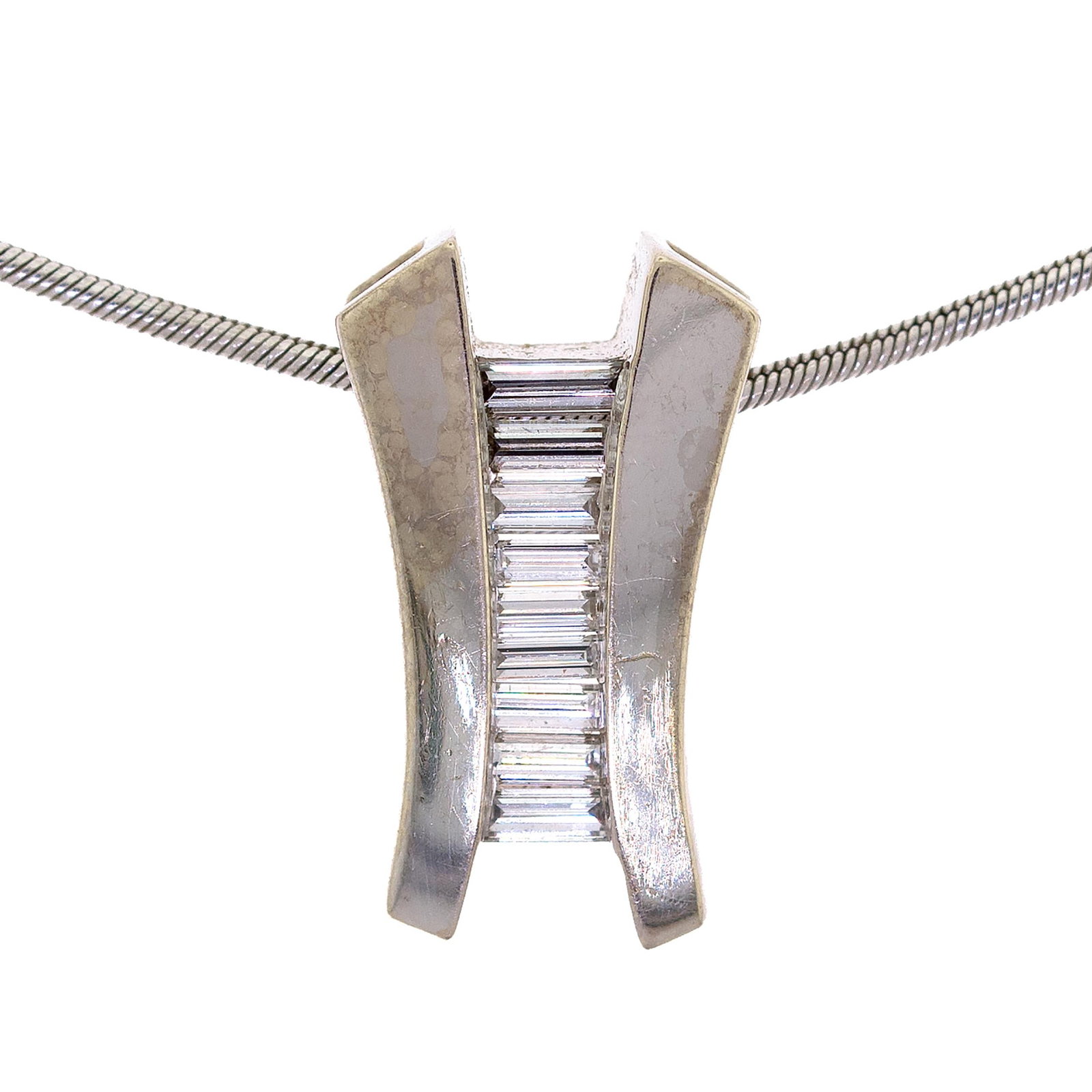 14K WHITE GOLD BAG DIAMOND SLIDE PENDANT & CHAIN.: A contemporary, 14k white gold (stamped) necklace with a slide pendant, channel set with approx. .75 ct. tw., baguette cut, natural diamonds of G-H color and VS clarity, approx. 3/4 inch long, with a 