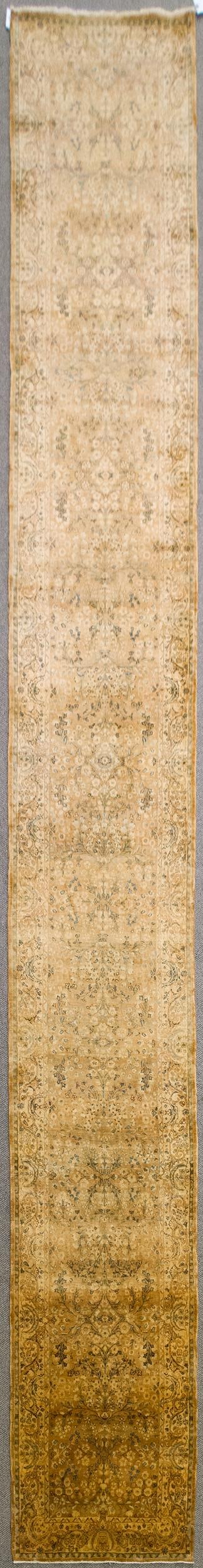 ANTIQUE ORIENTAL PERSIAN RUNNER RUG.: An antique hand woven Oriental Persian runner rug with peach ground, highlighted with ivory, black, and teal. 2'8” x 20’7”.