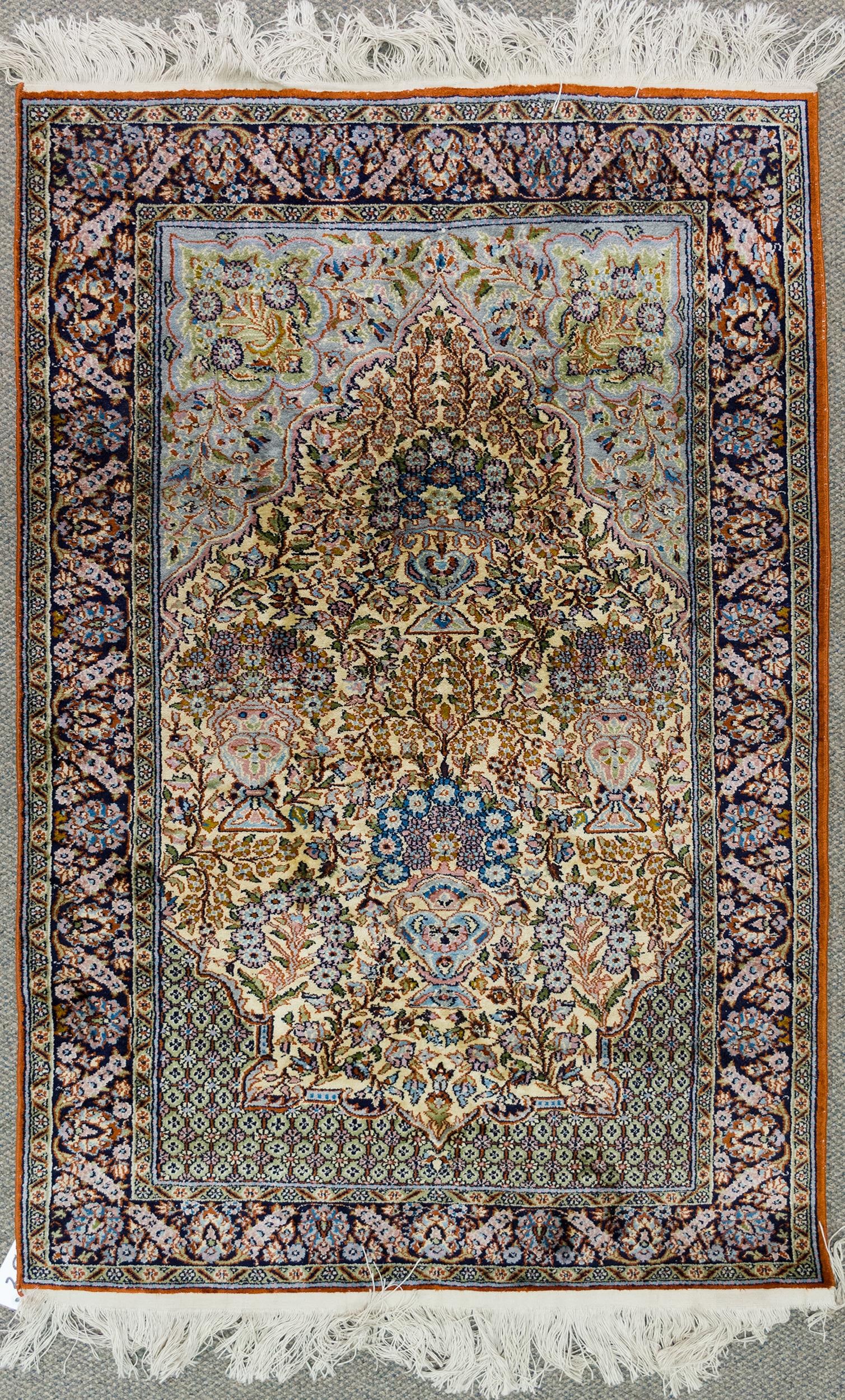 VINTAGE ORIENTAL SILK SCATTER RUG.: A vintage hand woven Oriental silk scatter rug with ivory ground, highlighted in aqua blue, green and red. 2’11” x 4’10”.