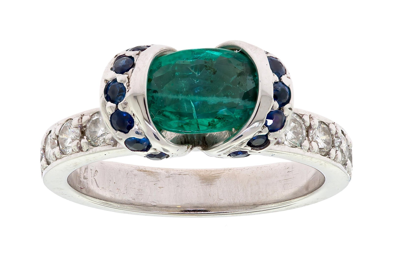14K GOLD EMERALD, SAPPHIRE & DIAMOND RING.: A 14k white gold (stamped) ring set with an approx. 1.35 ct., faceted oval, medium green emerald, approx. .28 ct. tw., faceted round, medium dark blue sapphires and approx. .50 ct. tw., round brillian