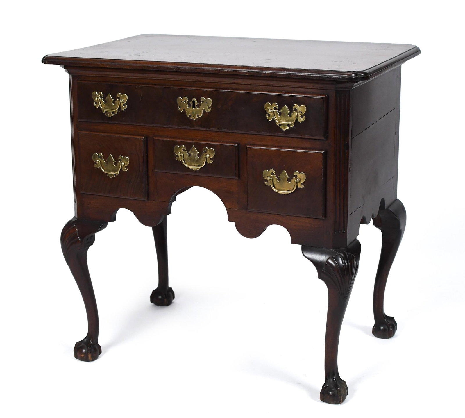 ANTIQUE CHIPPENDALE CARVED MAHOGANY LOW BOY.: A 19th C. Chippendale carved mahogany small low boy/dressing table with period brass. A carved molded edge top with notched c corners, one long over three short drawers, flanked by canted reeded corne