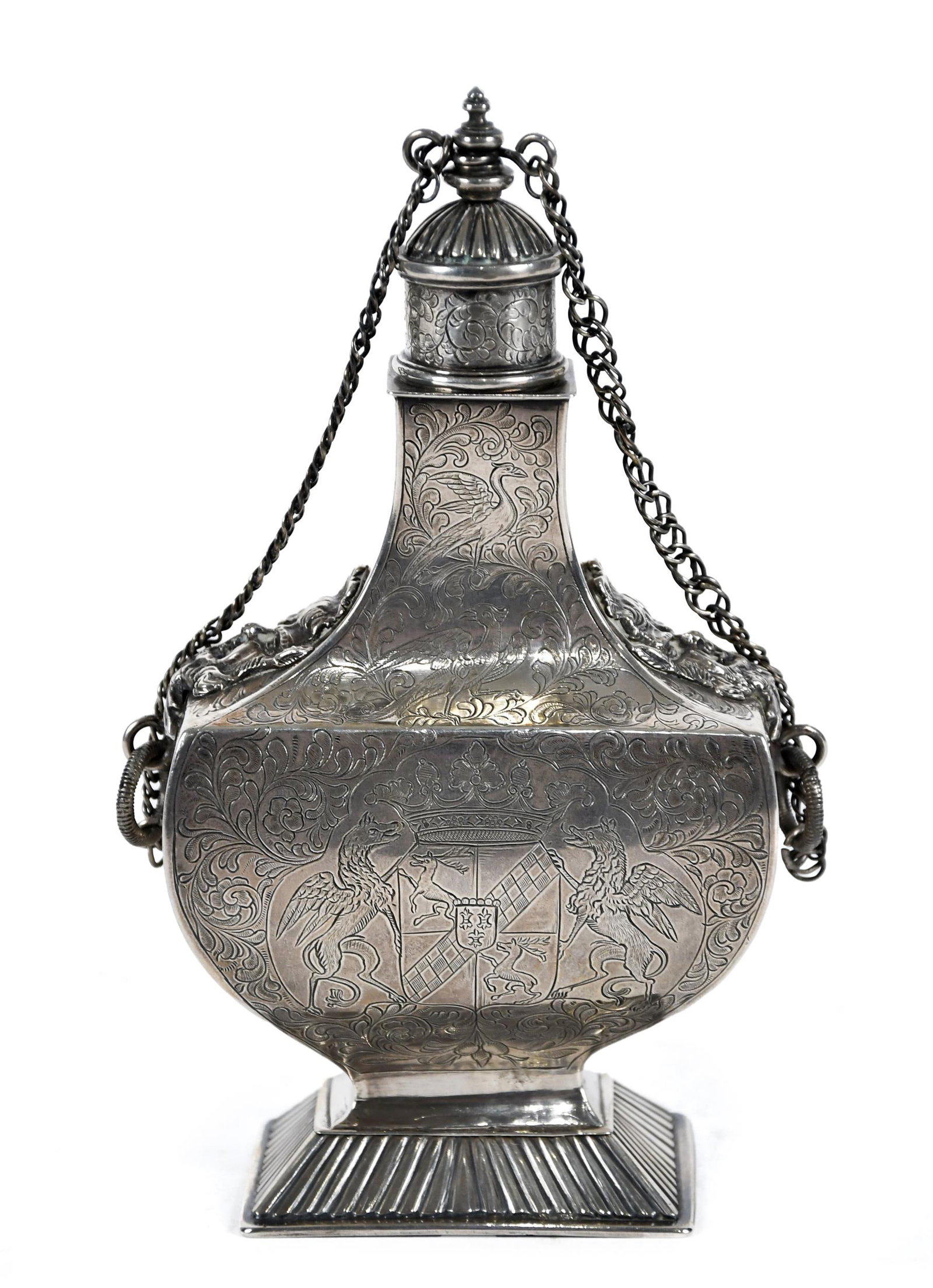 ANTIQUE SILVER TEA CADDY.: An antique silver bottle-form tea caddy, with attached lid, coat of arms decoration, hallmarked on bottom. 7”H, 10.8 oz t.