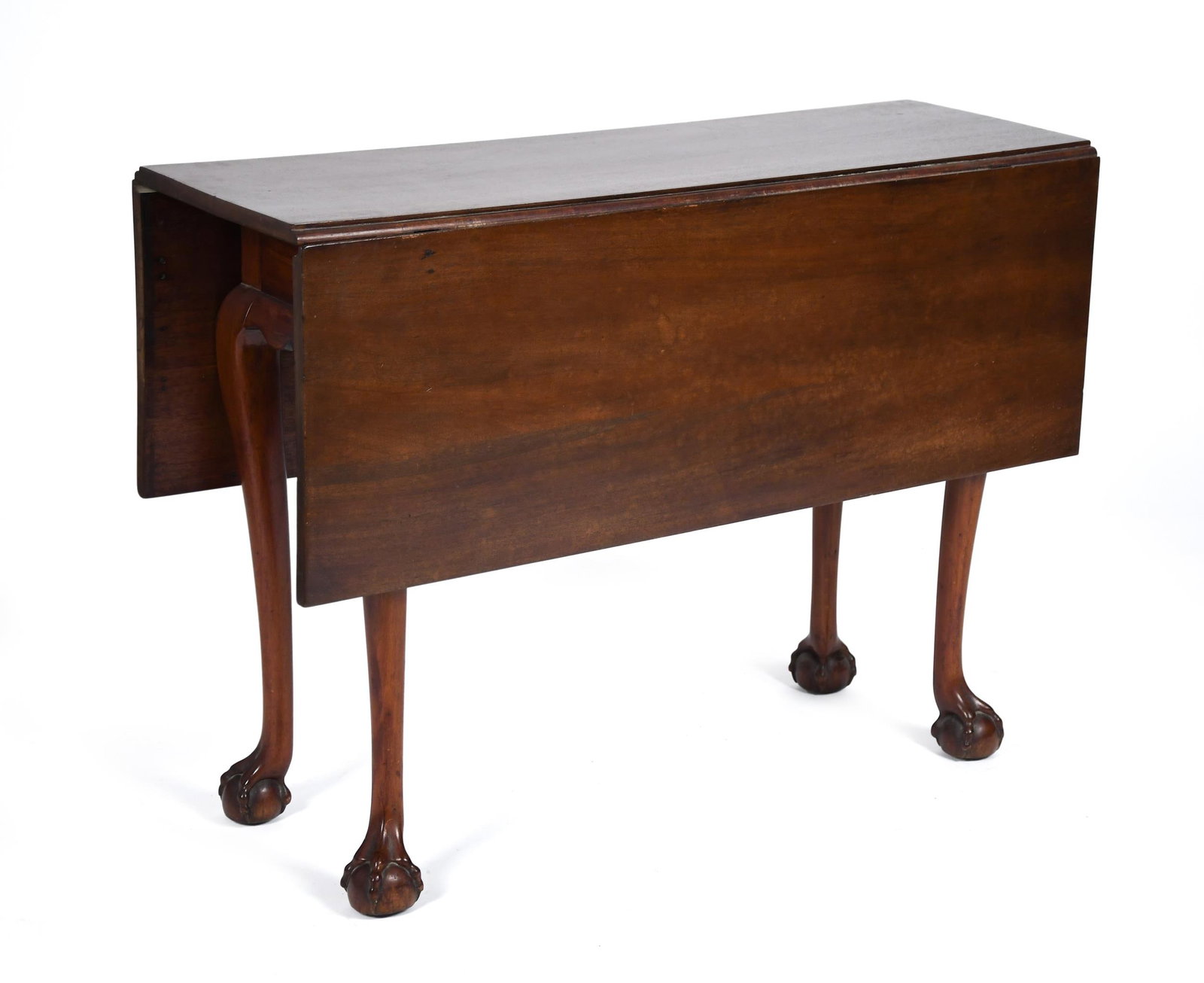 18TH C. NEW ENGLAND CHIPPENDALE DROP LEAF TABLE.: A ca. 1770 New England, likely Massachusetts, drop leaf mahogany table of diminutive proportions. Shaped aprons meet high carved cabriole legs with claw and ball feet. 28.5”H x 40”L x