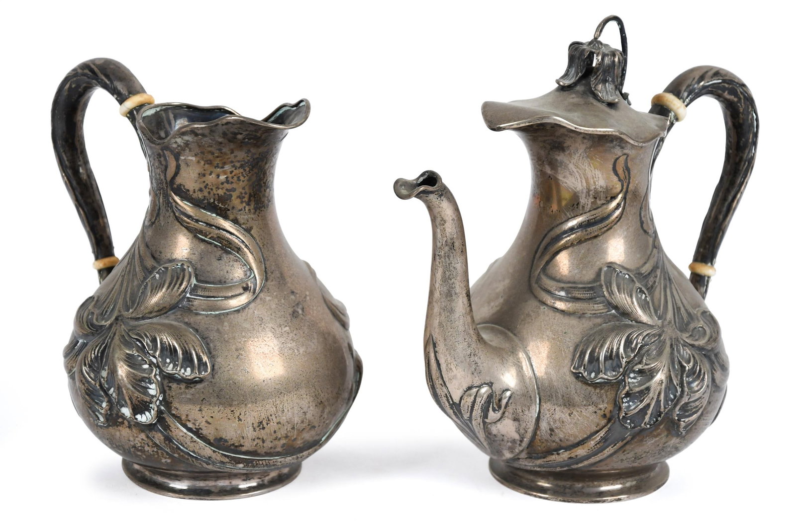 ANTIQUE FRENCH ART NOUVEAU STERLING PITCHER & TEAPOT.: Two French Art Nouveau floral reppouse sterling pieces, including a tea or coffee pot, 8.5”H and a cream pitcher, 7.5”H. 35 oz t.