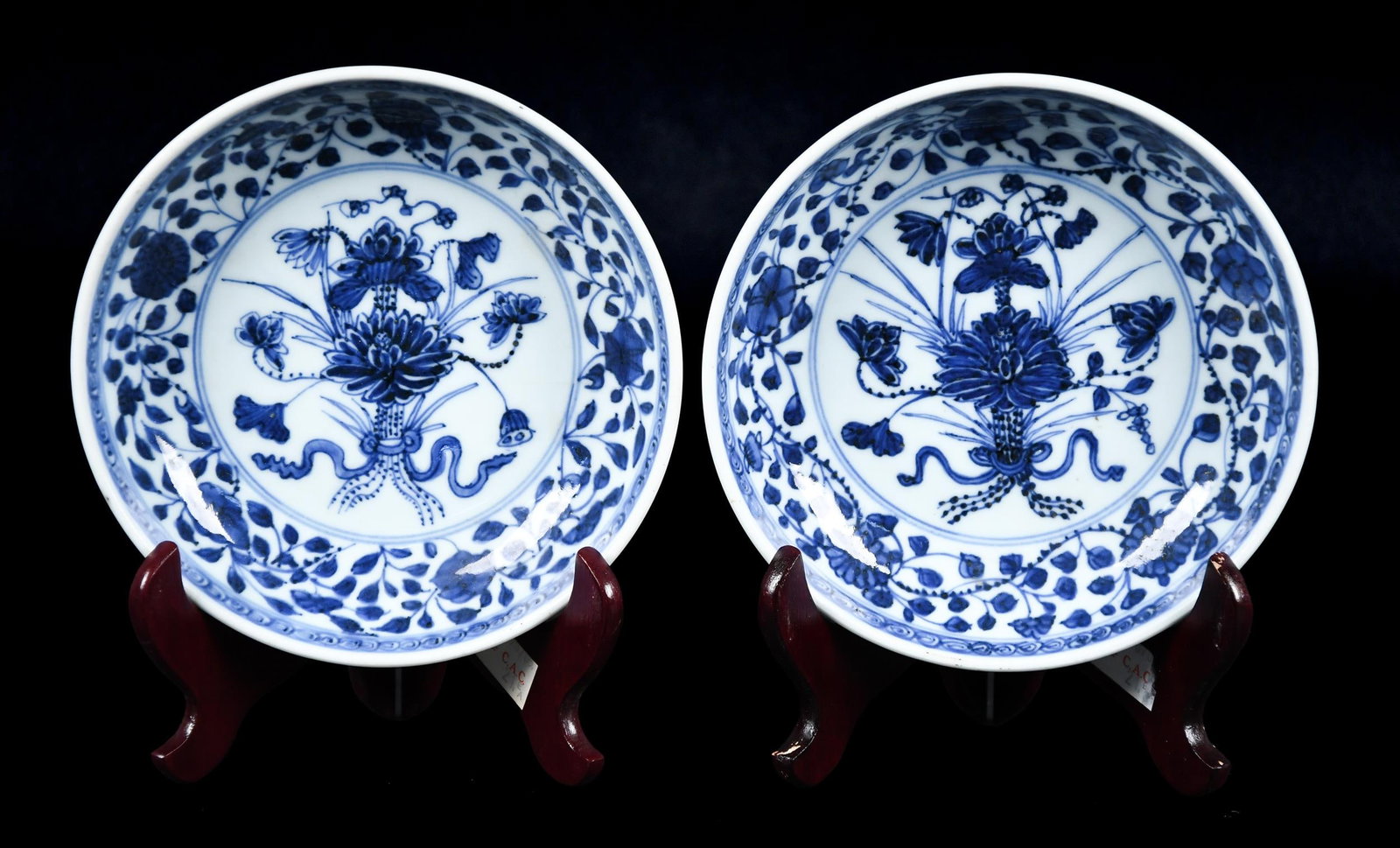 ANTIQUE BLUE AND WHITE CHINESE PORCELAIN BOWLS.: A good pair of antique Chinese porcelain blue and white decorated shallow bowls with floral motifs. Old label on reverse on one plate reads, ‘Ching Yung Chenu 1723-1736’. Each 6.25” 