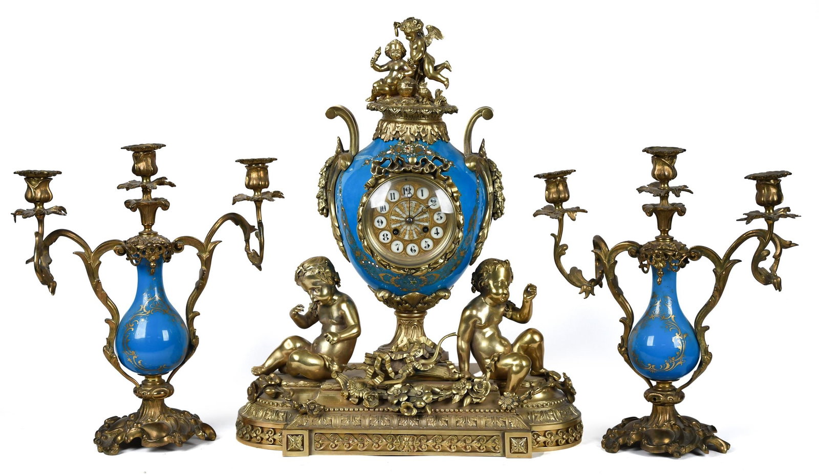 ANTIQUE FRENCH SEVRES STYLE 3PC CLOCK SET.: A good antique French three piece clock set. The clock and matching garnitures are constructed with rich blue hand painted Sevres style porcelain and mounted with figural dore brass. Clock 22”H 