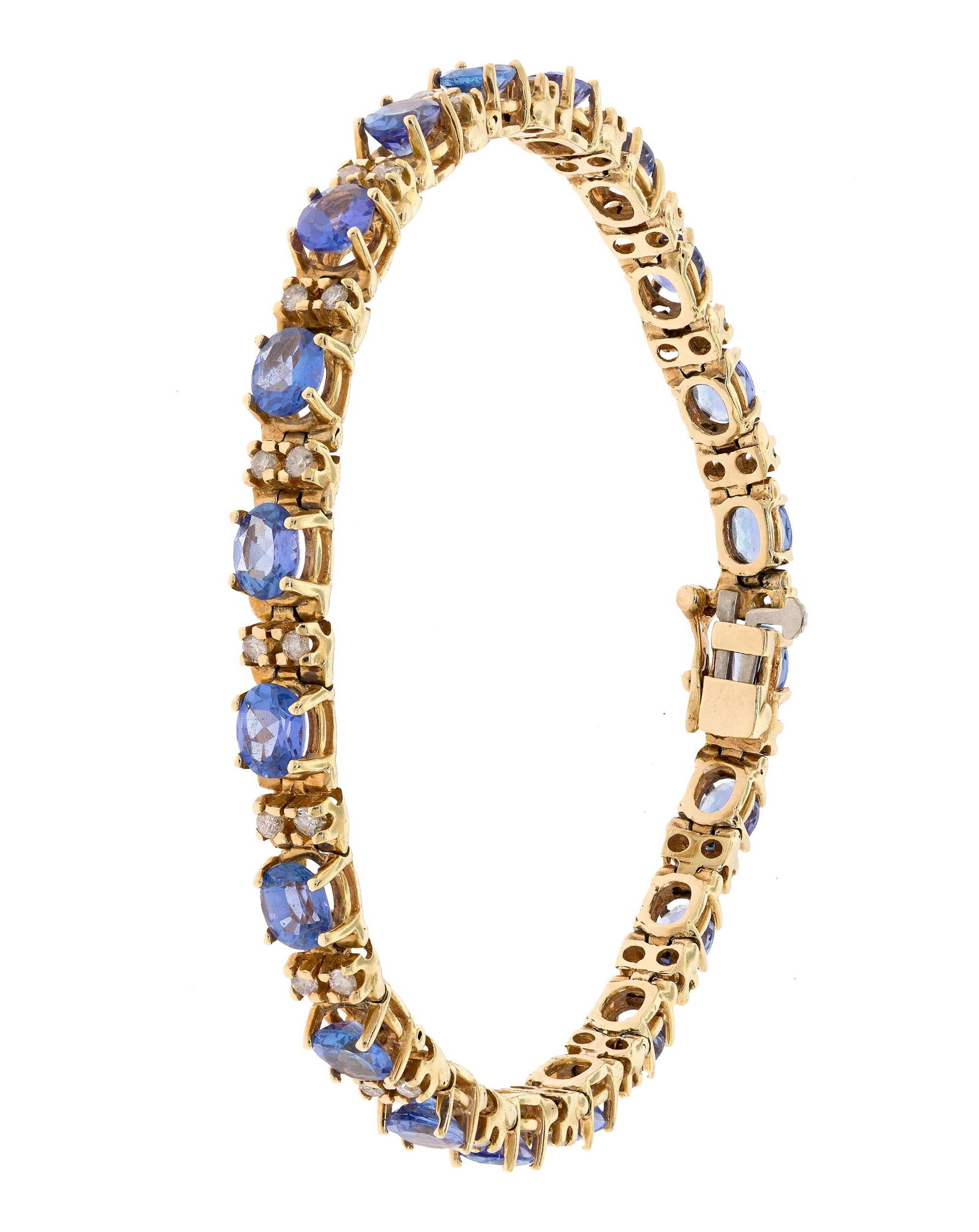 14K GOLD TANZANITE & DIAMOND LINE BRACELET.: A 14k yellow gold (stamped) line bracelet set with approx. 6.5 ct. tw., faceted oval, medium-dark, violetish blue, tanzanite and approx. .80 ct. tw., round brilliant cut, natural diamonds of H-I