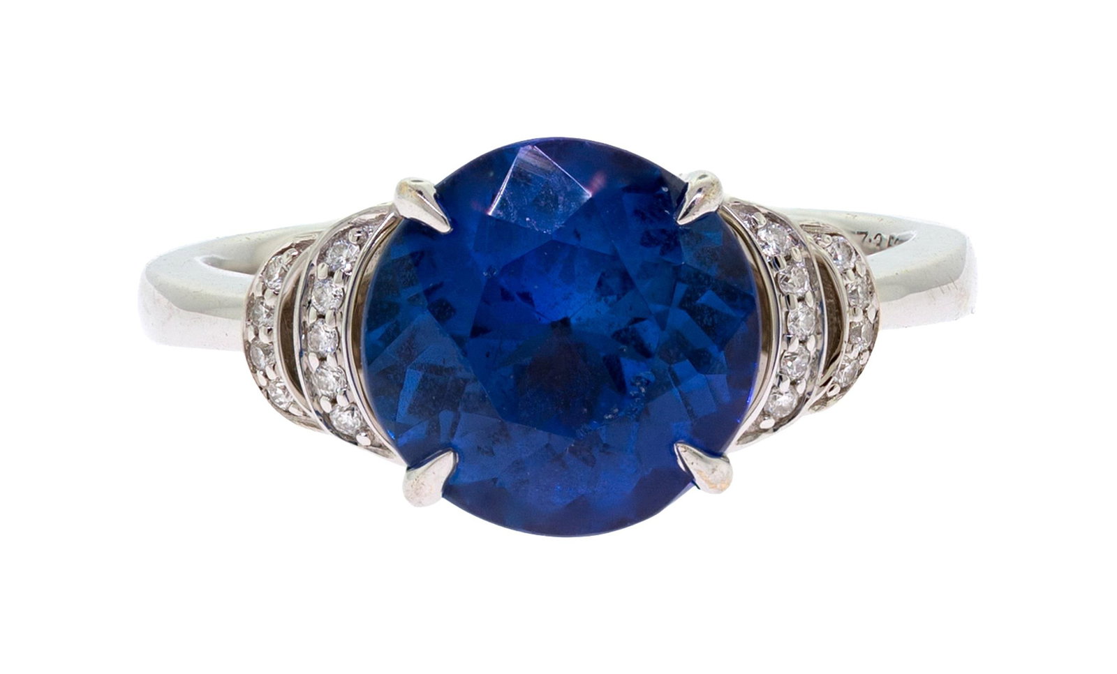 18K GOLD 3.53 CT. TANZANITE & DIAMOND RING.: An 18k white gold (stamped) ring, marked ADG, set with a 3.53 ct., faceted round, medium-dark, violetish-blue tanzanite and .06 ct. tw., round brilliant cut, natural diamonds of H color and VS
