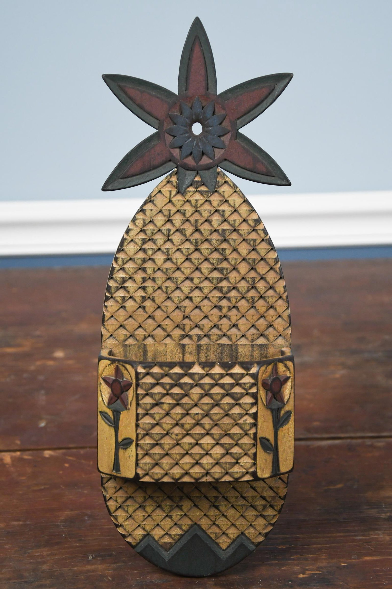 DOUGLASS 1994 PAINTED WOOD PINEAPPLE WALL BOX.: A 20th C. painted wood wall box, pineapple form, signed on reverse, Douglass 1994. 15”W x 5”W. Provenance: Warren Kimble Private Collection.