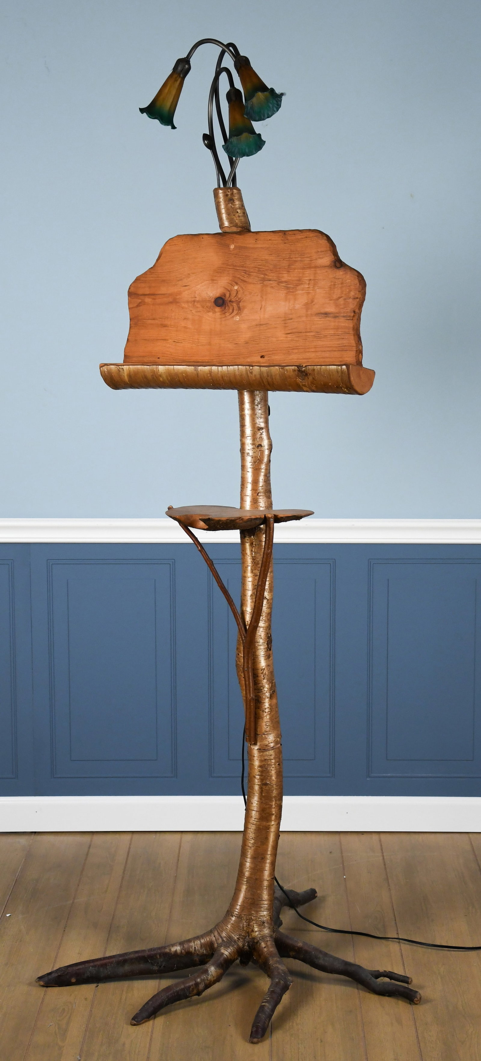 VINTAGE BIRCH ADIRONDACK LECTERN.: A vintage Adirondack lectern, made of birch branches, with art glass lamp in top. Illegibly signed on brass plaque on back. Warren Kimble provenance. 75”H x 23”W.