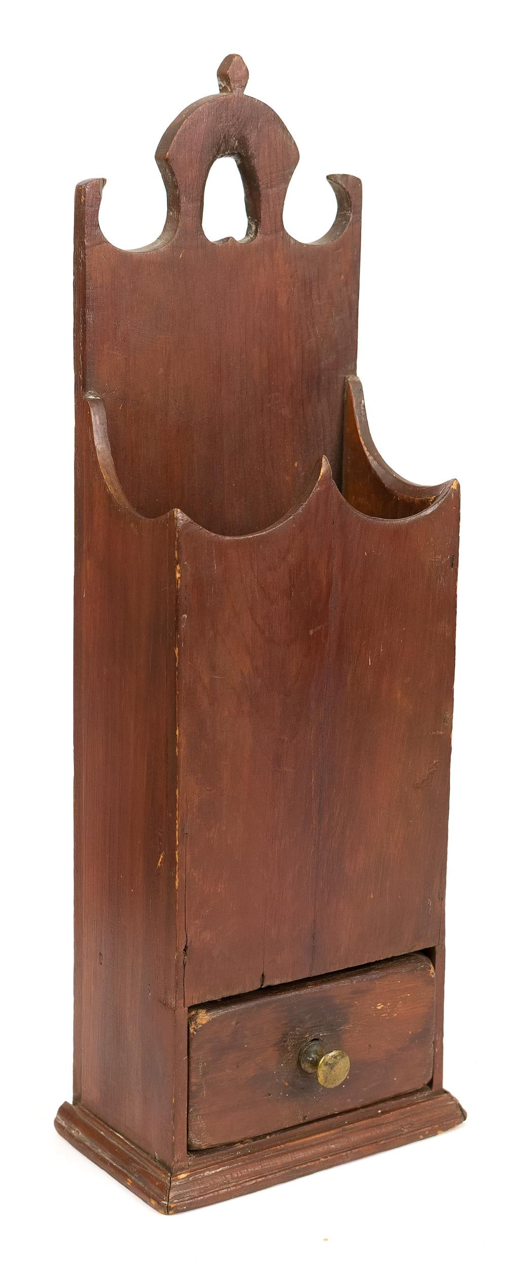 18TH C. RED STAINED NEW ENGLAND PIPE BOX.: An 18th C. New England one drawer pipe box in old red color, with an inverted heart cut out handle, scalloped sides, one dovetailed drawer on a molded base, 20”H x 7”W. Provenance: George