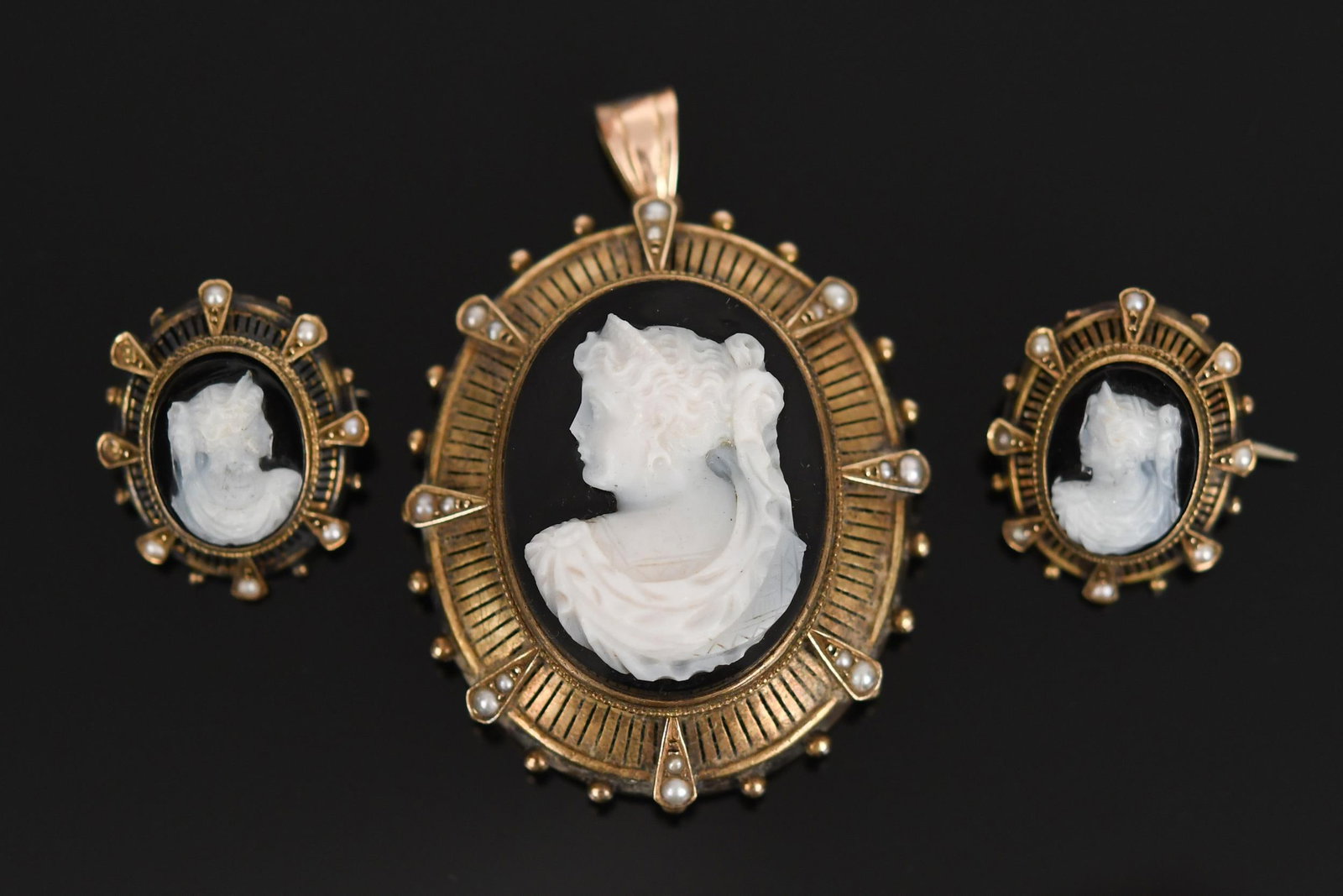 VICTORIAN 14K GOLD HARDSTONE CAMEO PEND & PINS.: Victorian, 14k yellow gold (tested) jewelry: hardstone cameo pendant with seed pearls and hair locket on reverse, approx. 2” long; two matching collar pins, approx. 1” long, 38.4 grams