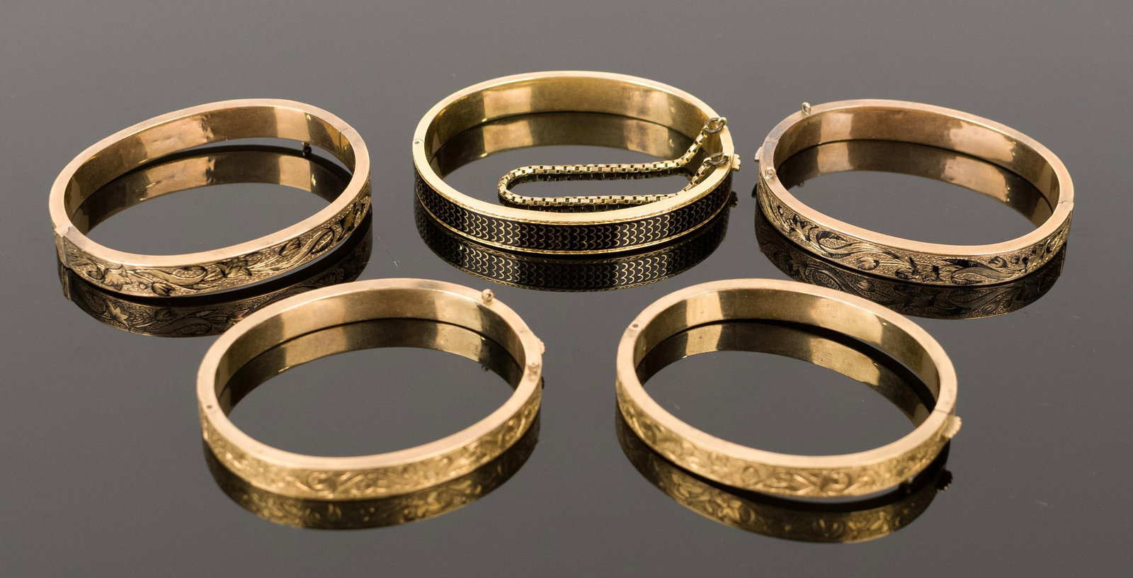 FIVE VICTORIAN GOLD CHILD'S BRACELETS.: Five, Victorian, yellow gold (tested), child's, hinged cuff, bangle bracelets: set of two, 10k, with hand engravings, 6mm wide, 19.6 grams; set of two, 14k gold, taille d'epargne (somewhat worn), 7mm