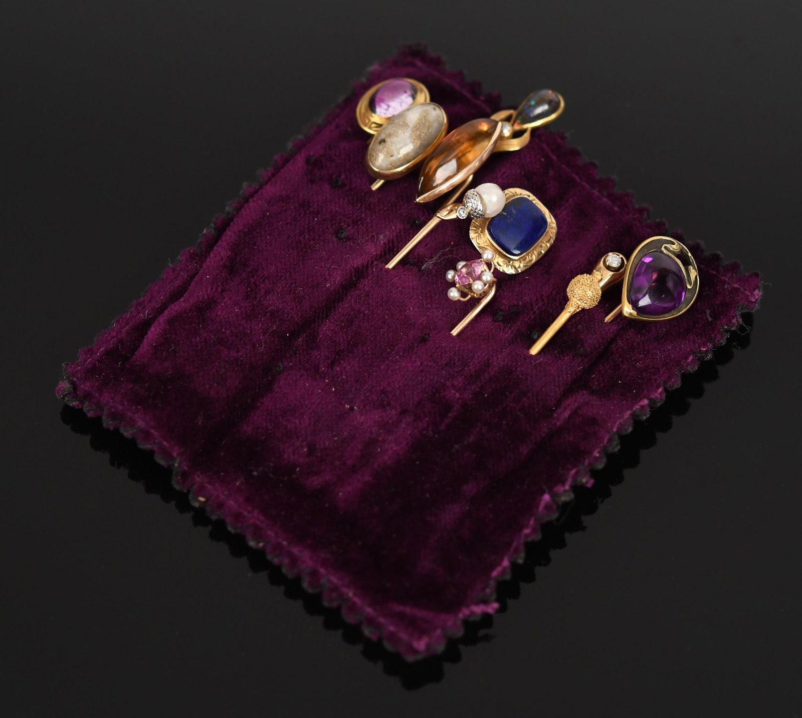 TEN ANTIQUE GOLD MULTI-STONE STICK PINS.: Ten antique, mostly 14k yellow gold (stamped or tested), stick pins, set with lapis, citrine, pearls, gold in quartz, small natural diamonds, approx. .30 ct. pink sapphire, amethyst and boulder opal, 