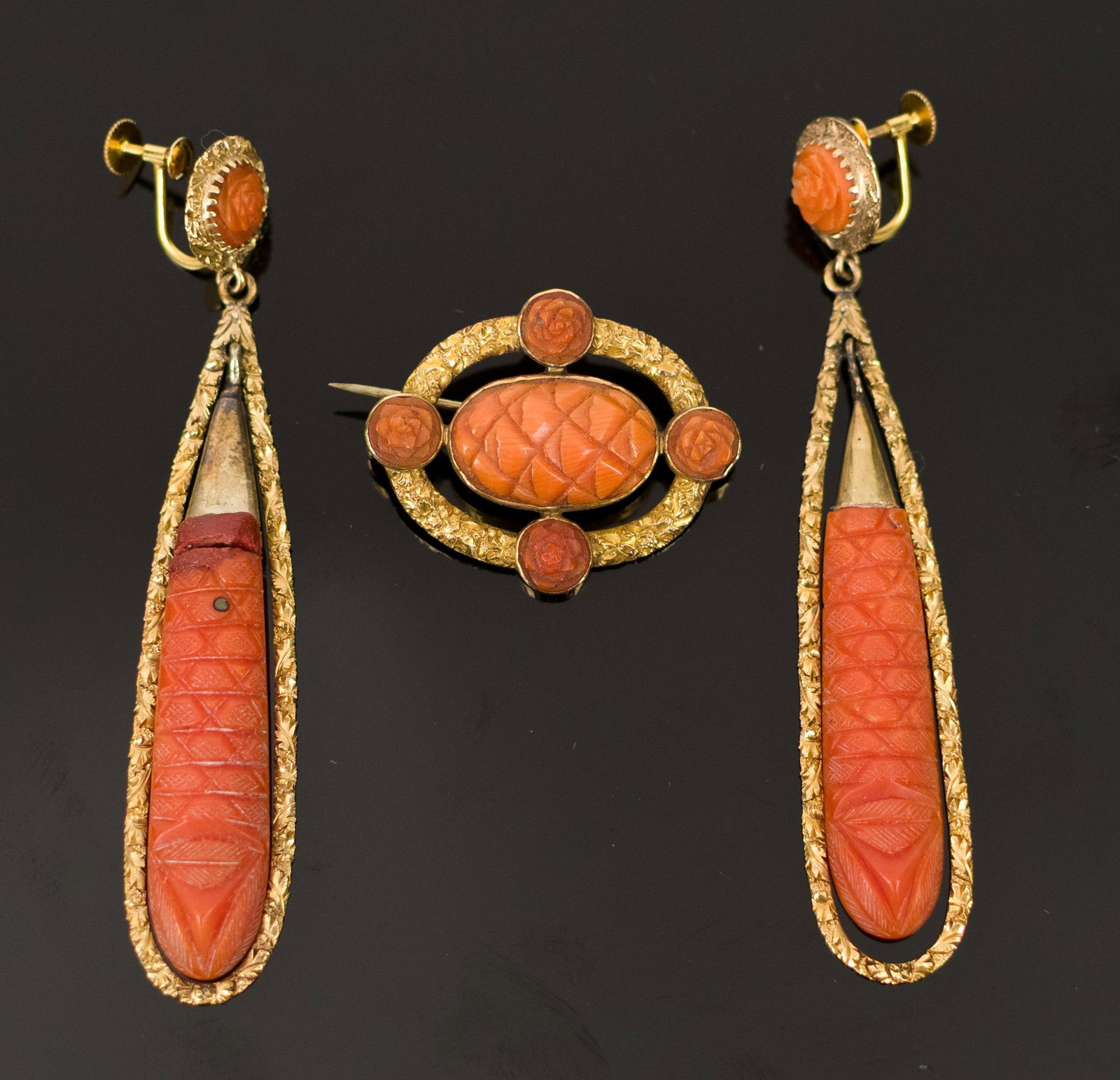 VICTORIAN 18K GOLD & CARVED CORAL EARRINGS & PIN.: Victorian, 18k yellow gold (tested and stamped), carved coral dangle, screwback earrings, 3 1/8” long and matching pin, 1 3/8” long, 11.0 grams (not including broken piece of coral in earr