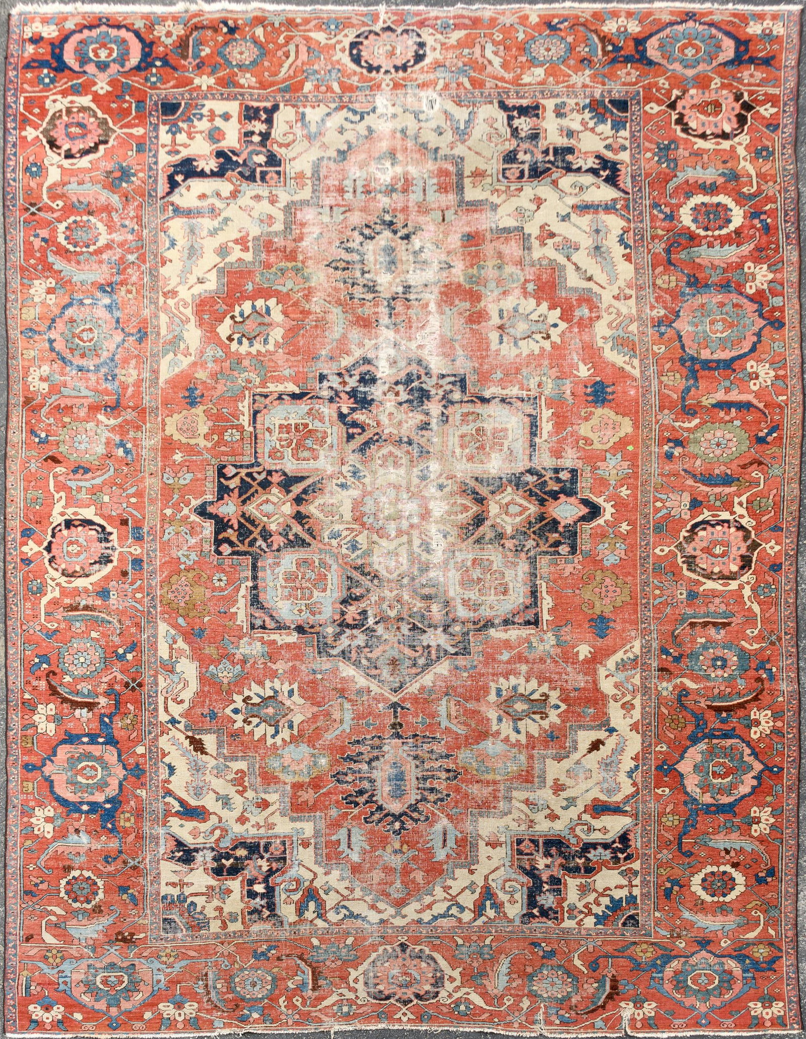 ANTIQUE ROOM SIZE HERIZ RUG.: An antique Oriental hand-woven room size Heriz or Serapi rug with center medallion in ivory with dark brown ground surrounded by brick red ground and ivory ground at corners with various designs
